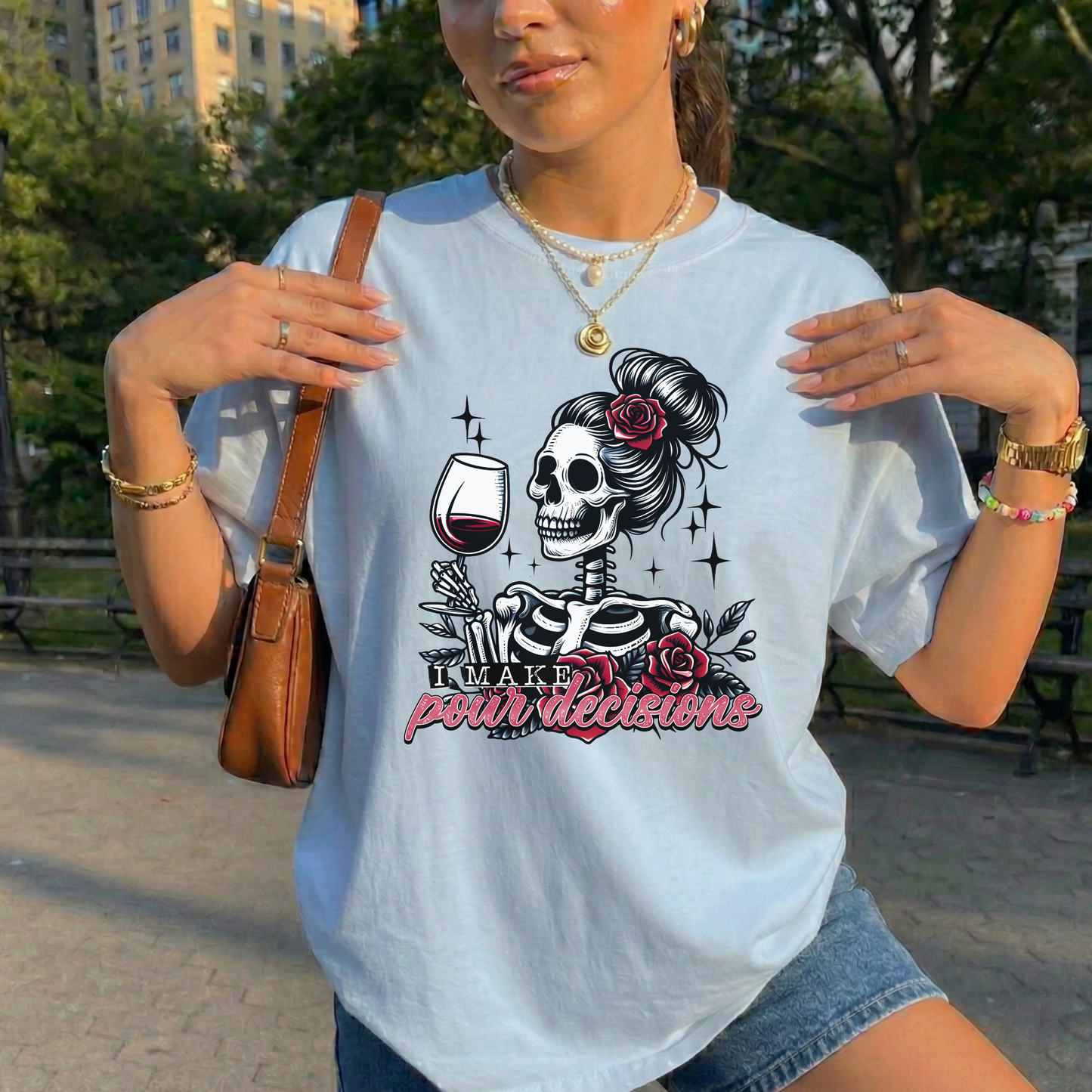 I Make Pour Decisions Shirt featuring a skeleton holding a glass of red wine with roses, sparkles, and funny wine-themed lettering. i make pour decisions shirt, wine lover shirt, funny wine shirt, wine mom shirt, skeleton wine shirt, wine drinking shirt, wine pun shirt, funny mom shirt, girls wine night shirt, vineyard outfit, spooky wine shirt, halloween wine shirt, wine enthusiast gift, wine tasting shirt, gothic wine shirt, funny drinking shirt, girls trip shirt, wine lover gift, skeleton shirt, wine hum