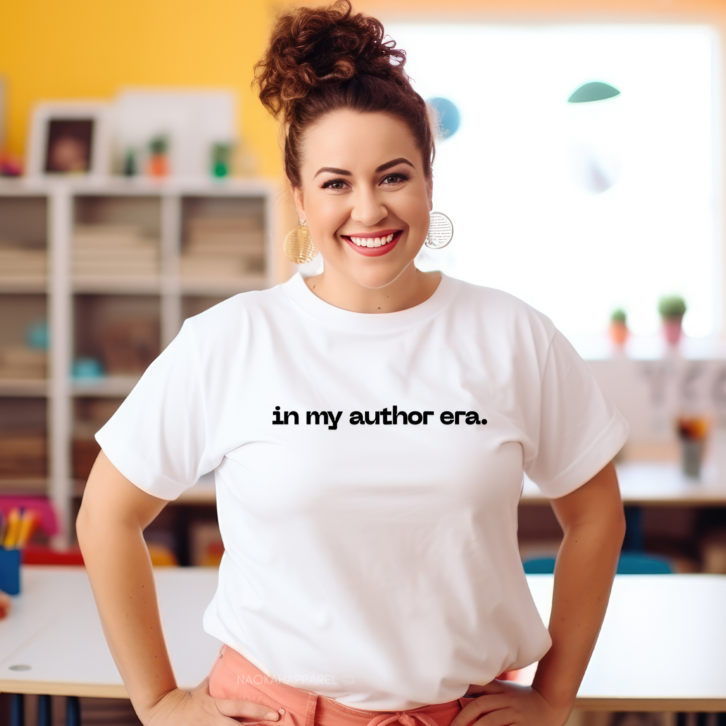 Woman wearing a white t-shirt with 'in my author era.' text in a classroom setting. in my author era shirt, writer shirt, author tee, writing shirt, nanowrimo shirt, book author apparel, novelist shirt, writer gift shirt, author era tee, creative writer clothing, book launch shirt, writing community tee, aspiring author shirt, fiction writer apparel, manuscript shirt
