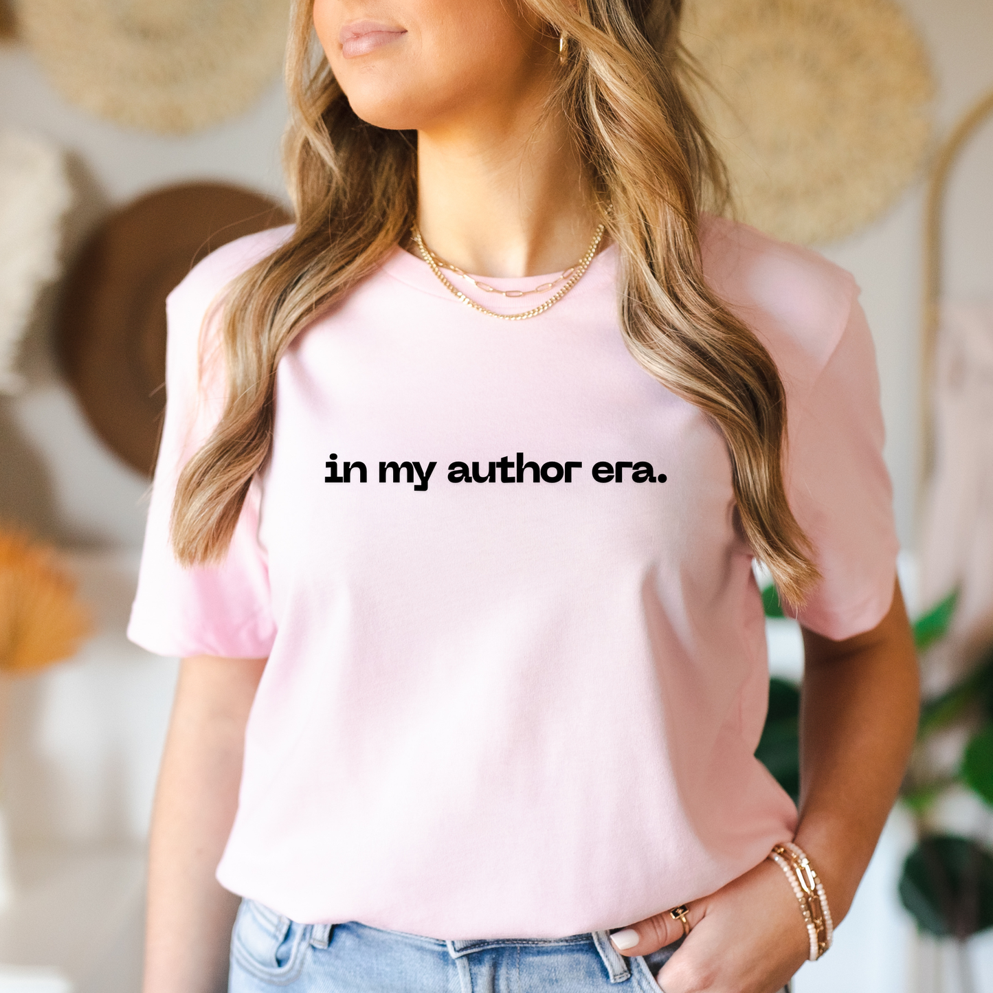 Person wearing a pink t-shirt with 'in my author era.' text, standing against a blurred background. in my author era shirt, writer shirt, author tee, writing shirt, nanowrimo shirt, book author apparel, novelist shirt, writer gift shirt, author era tee, creative writer clothing, book launch shirt, writing community tee, aspiring author shirt, fiction writer apparel, manuscript shirt
