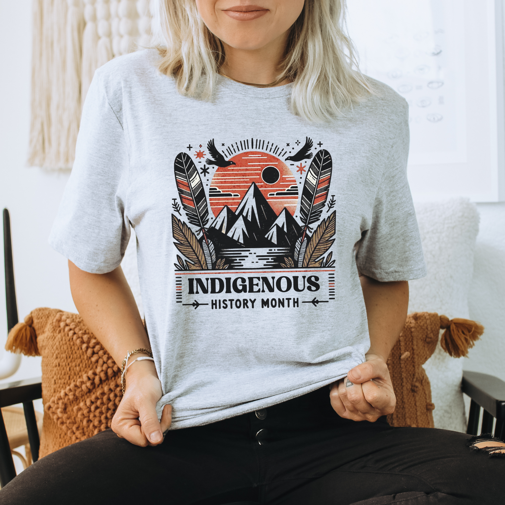 Indigenous History Month shirt with mountain, feather, and sun graphic in black, white, and earth tones on a unisex t-shirt. indigenous history month shirt, indigenous pride tee, mountain feather sun design, unisex graphic tee, cultural celebration shirt, indigenous apparel, native pride shirt, heritage clothing, meaningful statement tee, everyday wear shirt, community event shirt, indigenous month shirt, bold graphic tee, indigenous history apparel, celebration shirt