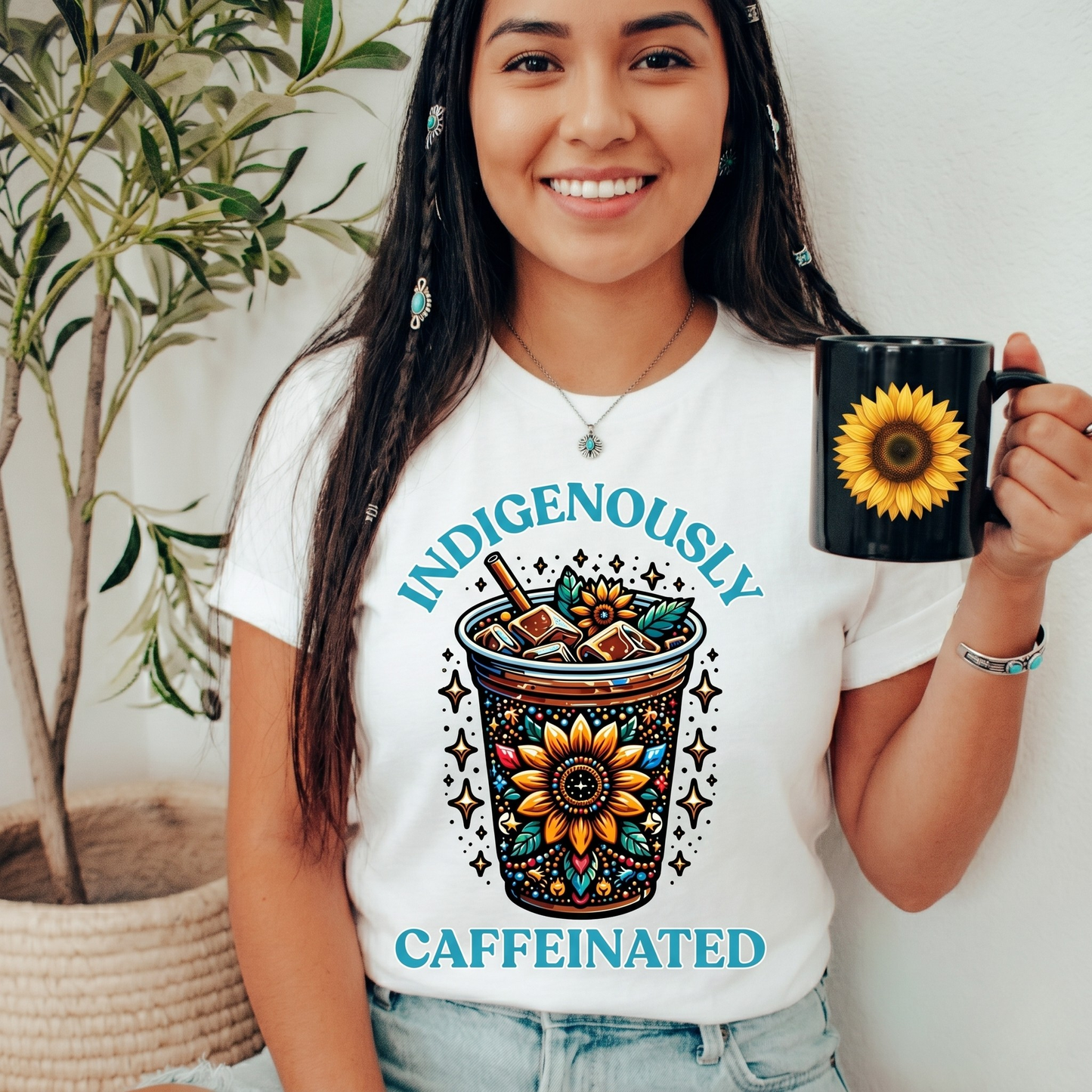 t-shirt featuring a vibrant Indigenous-inspired floral iced coffee design with the phrase "Indigenously Caffeinated" in turquoise lettering. indigenously caffeinated shirt, indigenous coffee lover shirt, indigenous graphic tee, native coffee shirt, coffee lover apparel, indigenous pride clothing, floral coffee design shirt, indigenous entrepreneur shirt, caffeine lover gift, indigenous fashion canada, indigenous art t-shirt, iced coffee graphic tee, indigenous gift ideas, coffee addict shirt, indigenous sma