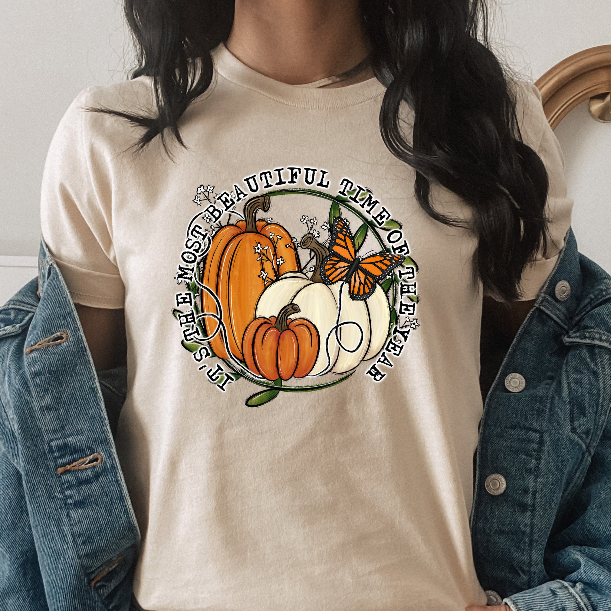unisex t-shirt featuring pumpkins, a monarch butterfly, leafy accents, and the phrase "It's The Most Beautiful Time Of The Year" in a circular autumn-inspired design. it's the most beautiful time of the year shirt, fall shirt, autumn shirt, pumpkin shirt, pumpkin season shirt, thanksgiving shirt, fall graphic tee, cozy autumn shirt, pumpkin patch shirt, sweater weather shirt, fall aesthetic, harvest shirt, halloween shirt, pumpkin lover gift, autumn outfit, farmhouse fall decor shirt, monarch butterfly