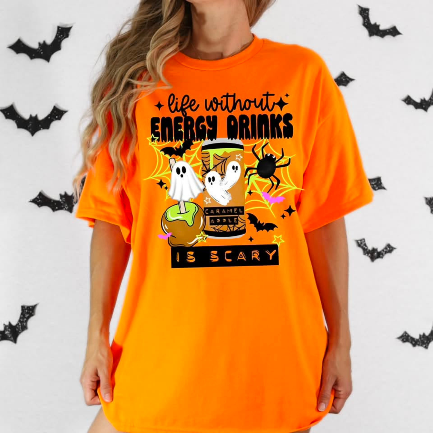 Funny Life Without Energy Drinks Is Scary Halloween shirt with ghosts, bats, spider webs, caramel apple, and spooky energy drink design. life without energy drinks is scary shirt, funny halloween shirt, energy drink shirt, caffeine lover shirt, halloween ghost shirt, spooky season shirt, funny fall shirt, halloween graphic tee, gamer shirt, nurse halloween shirt, teacher halloween shirt, student shirt, caffeine addict shirt, halloween apparel, caramel apple shirt, ghost aesthetic shirt, spooky cute shirt