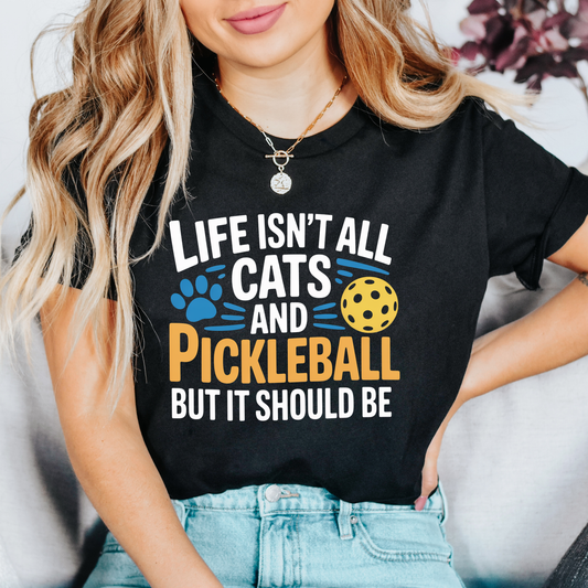 Life Isn’t All Cats and Pickleball But It Should Be shirt, funny pickleball and cat lover graphic tee, unisex casual t-shirt design, pickleball shirt, cat lover shirt, funny pickleball tee, cat mom shirt, pickleball gift, funny cat shirt, sports graphic tee, pickleball outfit, cute cat shirt, cat lover gift, unisex graphic tee, casual funny shirt