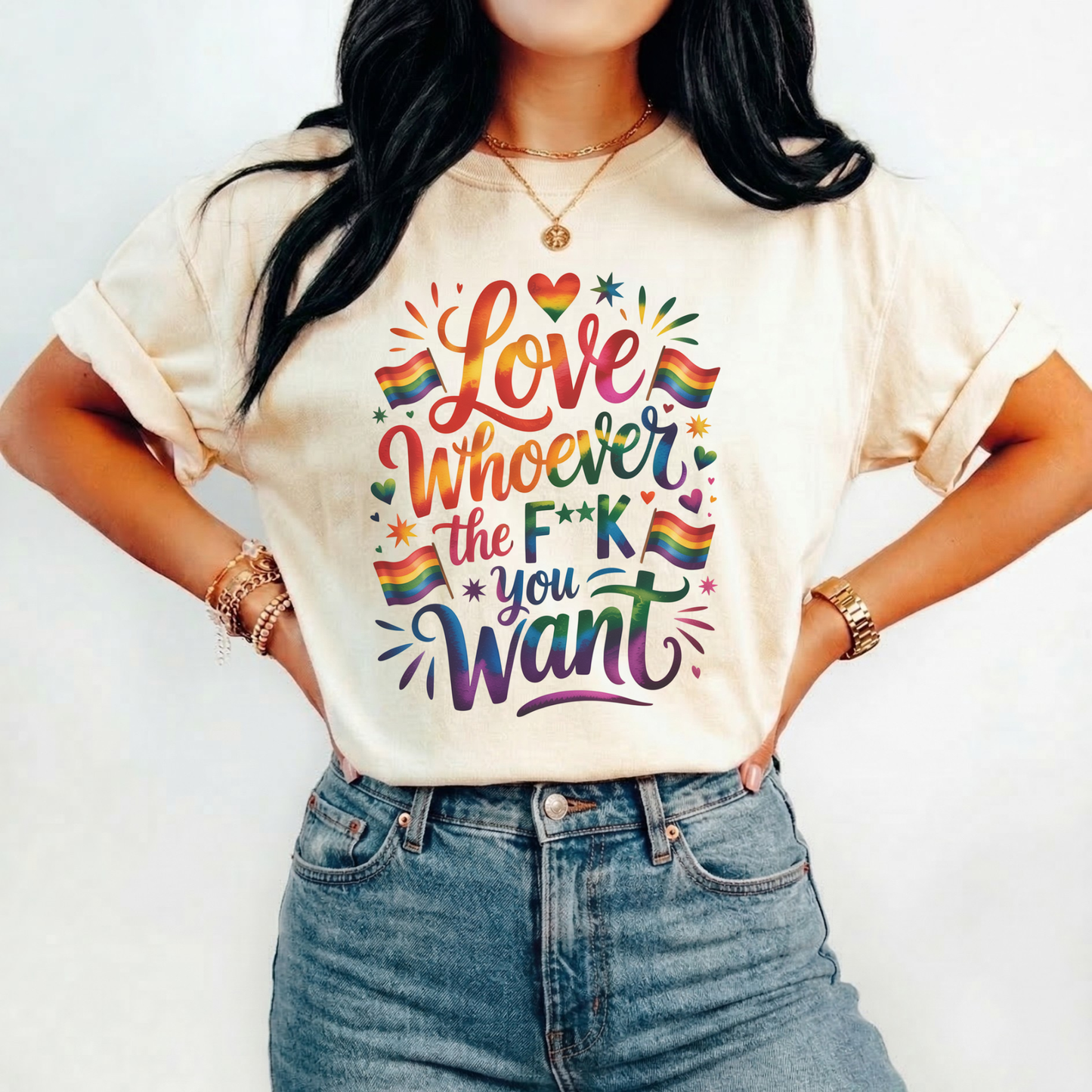 Person wearing a t-shirt with colorful text and rainbow flags on a plain background. love is love, pride shirt, equality apparel, inclusive clothing, feminist tee, graphic shirt, LGBTQ+ fashion, Indigenous brand, Toronto streetwear, statement tee, self-expression shirt