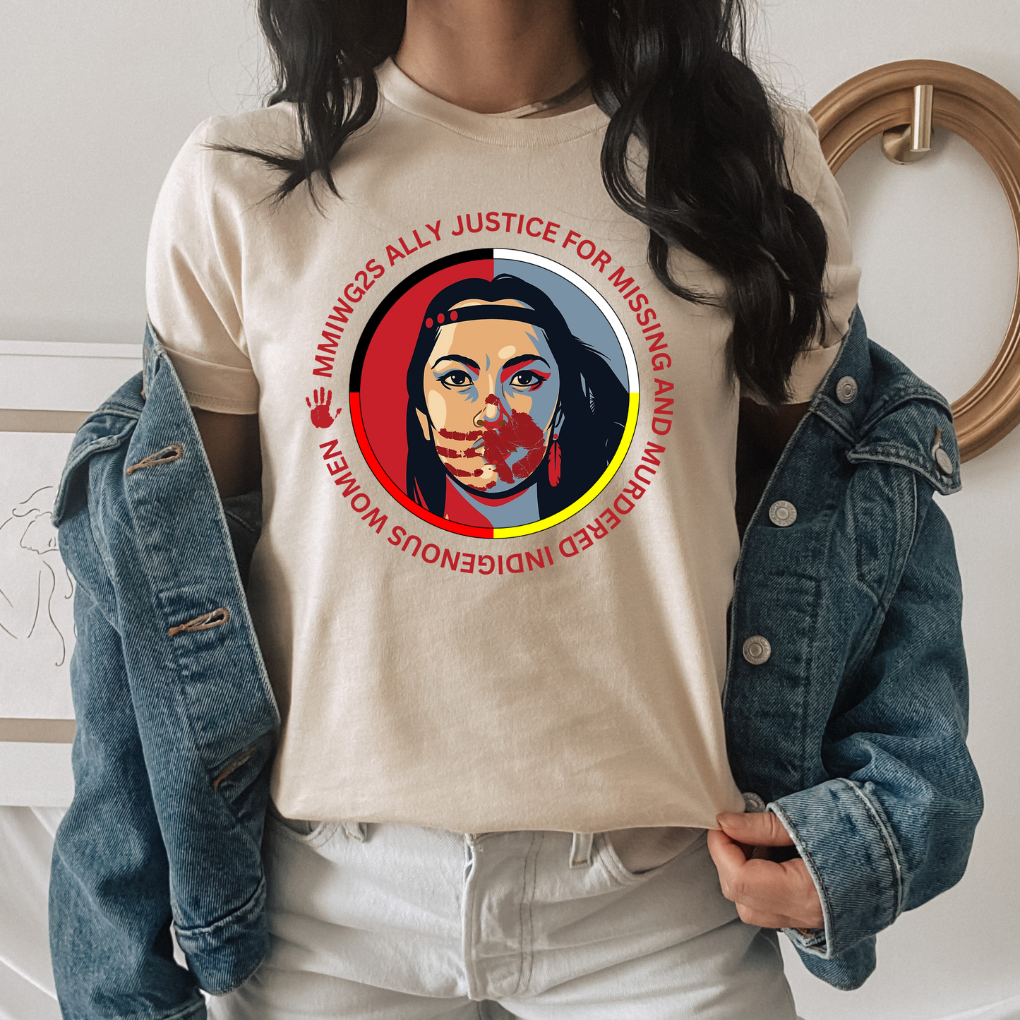 Person wearing a beige t-shirt with a graphic design and text, standing indoors. MMIWG2S shirt, Missing Murdered Indigenous Women tee, Indigenous ally shirt, MMIWG awareness apparel, justice for Indigenous women clothing, truth and reconciliation tee, National Day for Truth shirt, Indigenous activism clothing, 2SLGBTQQIA ally shirt, Canada missing women awareness, social justice tee, rally shirt Indigenous rights, solidarity shirt, awareness apparel Indigenous, activism t-shirt