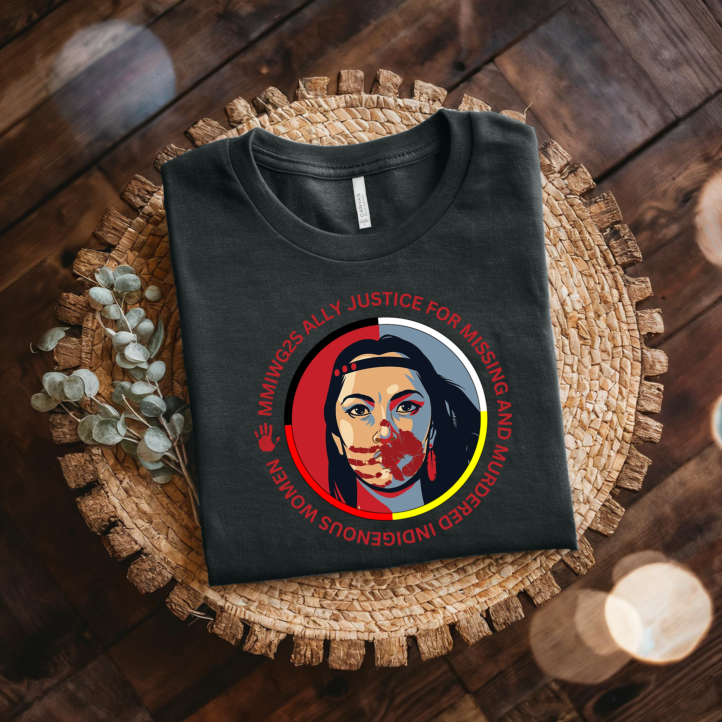 Black t-shirt with a graphic design on a woven mat. MMIWG2S shirt, Missing Murdered Indigenous Women tee, Indigenous ally shirt, MMIWG awareness apparel, justice for Indigenous women clothing, truth and reconciliation tee, National Day for Truth shirt, Indigenous activism clothing, 2SLGBTQQIA ally shirt, Canada missing women awareness, social justice tee, rally shirt Indigenous rights, solidarity shirt, awareness apparel Indigenous, activism t-shirt
