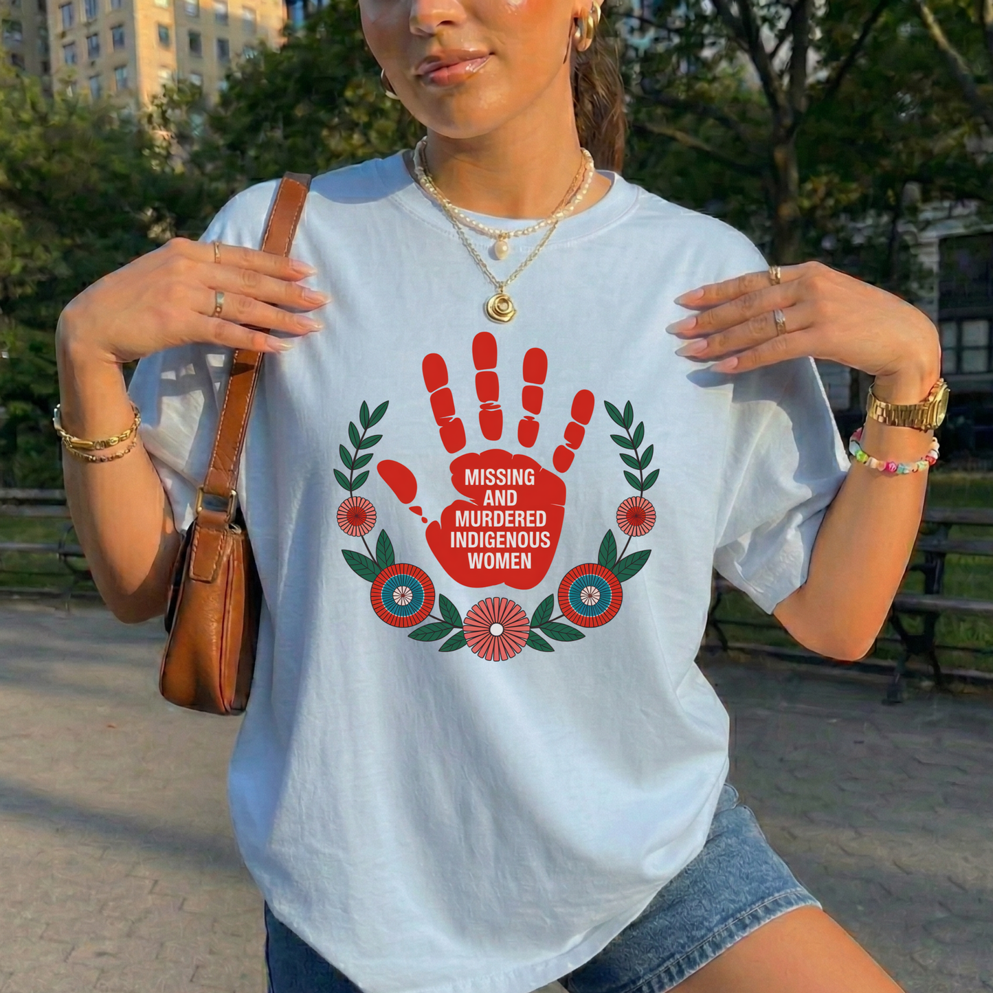 Person wearing a white t-shirt with a red handprint design and text, standing outdoors. MMIW shirt, Missing and Murdered Indigenous Women shirt, red handprint shirt, Indigenous awareness shirt, Indigenous rights shirt, MMIW awareness tee, solidarity shirt, social justice shirt, unisex awareness shirt, Canada Indigenous shirt, Indigenous activism clothing, reconciliation shirt, advocate shirt, meaningful graphic tee, awareness apparel