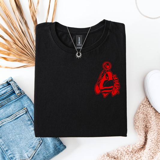Black t-shirt with red graphic design on a white surface with denim jeans and a white cup. MMIW shirt, MMIW woman in feathers, pocket design shirt, Indigenous awareness tee, Missing and Murdered Indigenous Women, Indigenous graphic tee, unisex t shirt, activism shirt, Indigenous justice, feather shirt, awareness apparel, Native shirt, statement tee, solidarity shirt, Indigenous owned brand