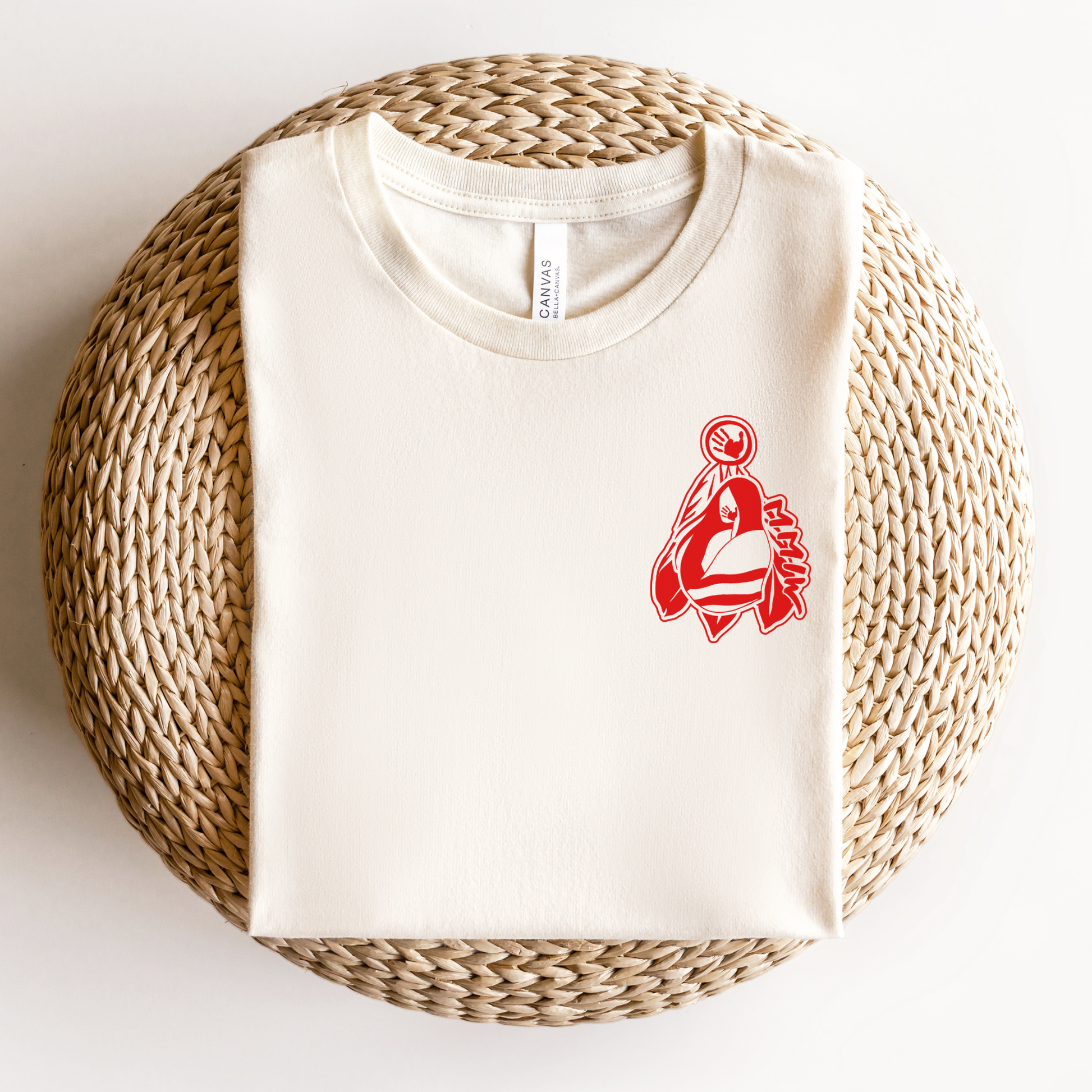 White t-shirt with red logo on a woven bal. MMIW shirt, MMIW woman in feathers, pocket design shirt, Indigenous awareness tee, Missing and Murdered Indigenous Women, Indigenous graphic tee, unisex t shirt, activism shirt, Indigenous justice, feather shirt, awareness apparel, Native shirt, statement tee, solidarity shirt, Indigenous owned brandl