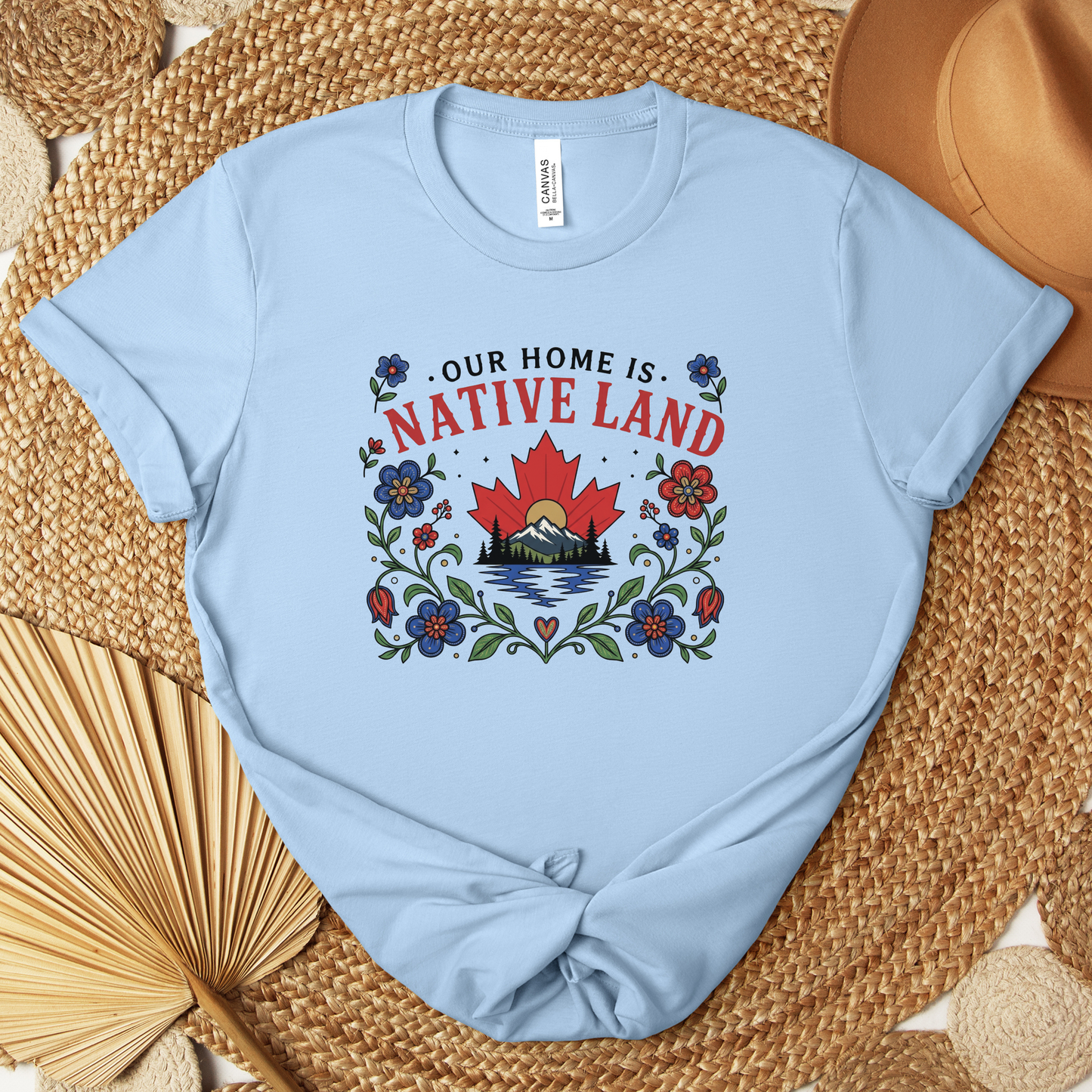 Our Home Is Native Land shirt, Indigenous Canada Day shirt, Indigenous floral maple leaf shirt, Native land graphic tee, Indigenous designed apparel, Indigenous-owned clothing, reconciliation shirt, National Indigenous Peoples Day shirt, Canadian mountain shirt, maple leaf floral shirt, Indigenous fashion Canada, Truth and Reconciliation apparel, Canadian landscape shirt, Indigenous artist shirt, support Indigenous business