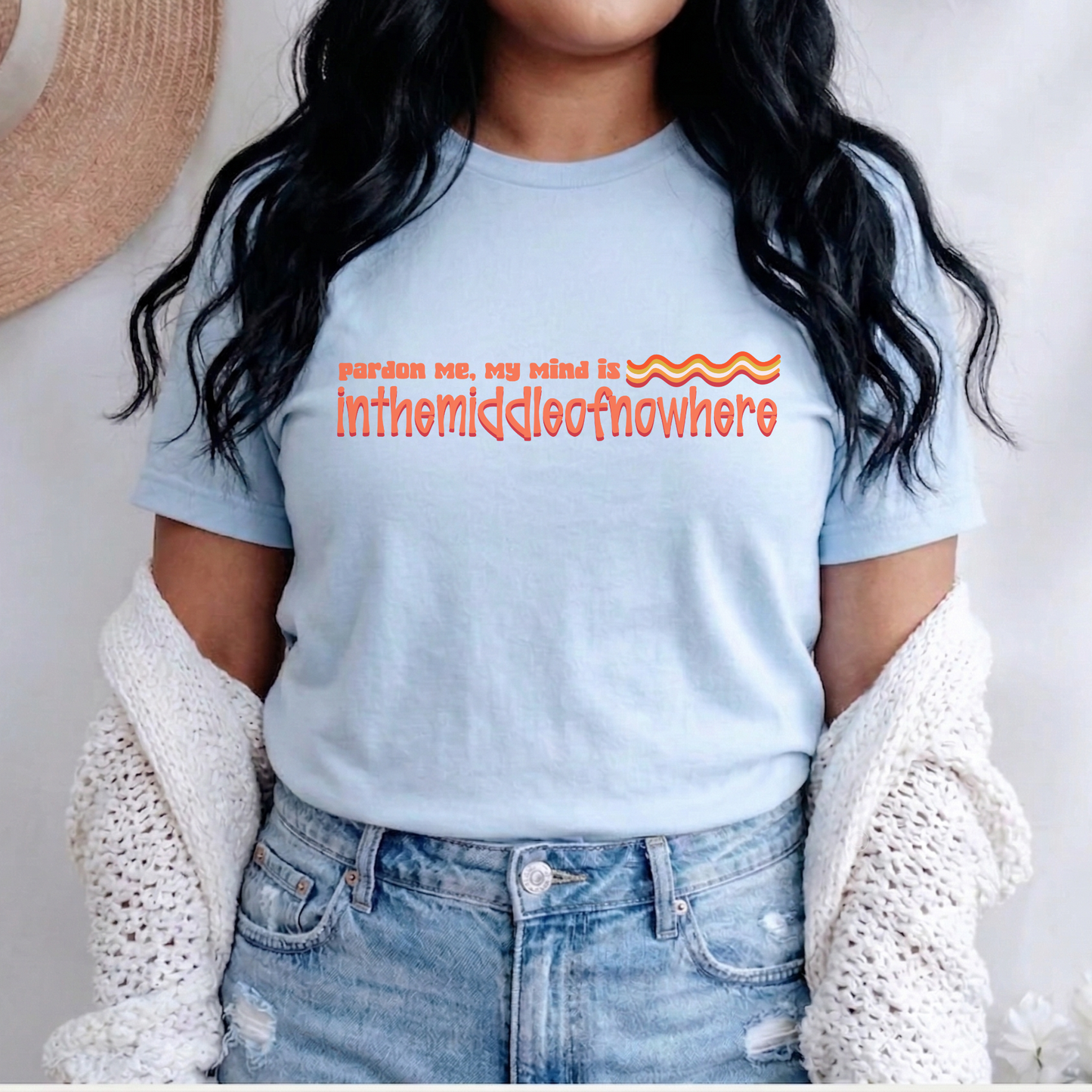 Person wearing a light blue t-shirt with orange text, standing against a neutral background. funny quote shirt, sarcastic t shirt, unisex graphic tee, humor tee, funny saying shirt, casual quote shirt, statement tee, laid back shirt, daydreaming shirt, witty t shirt, gift idea shirt, funny unisex tee, everyday graphic tee, relaxed style shirt, humorous apparel