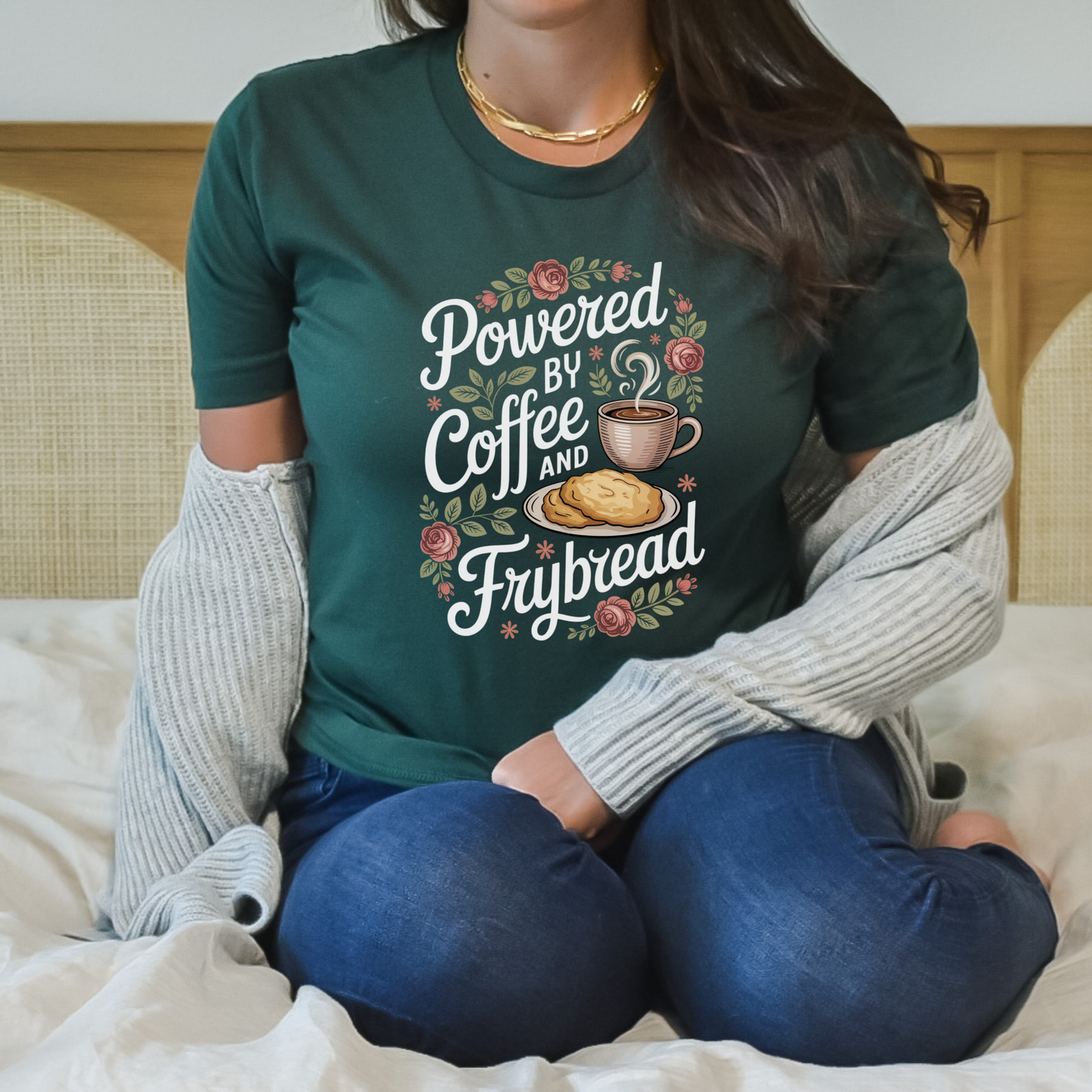Person wearing a green t-shirt with 'Powered by Coffee and Frybread' design. coffee shirt, frybread shirt, indigenous shirt, funny indigenous shirt, coffee lover tee, cultural apparel, indigenous inspired clothing, casual graphic tee, funny t shirt, foodie shirt, native humor shirt, everyday wear tee, statement shirt, gift idea shirt