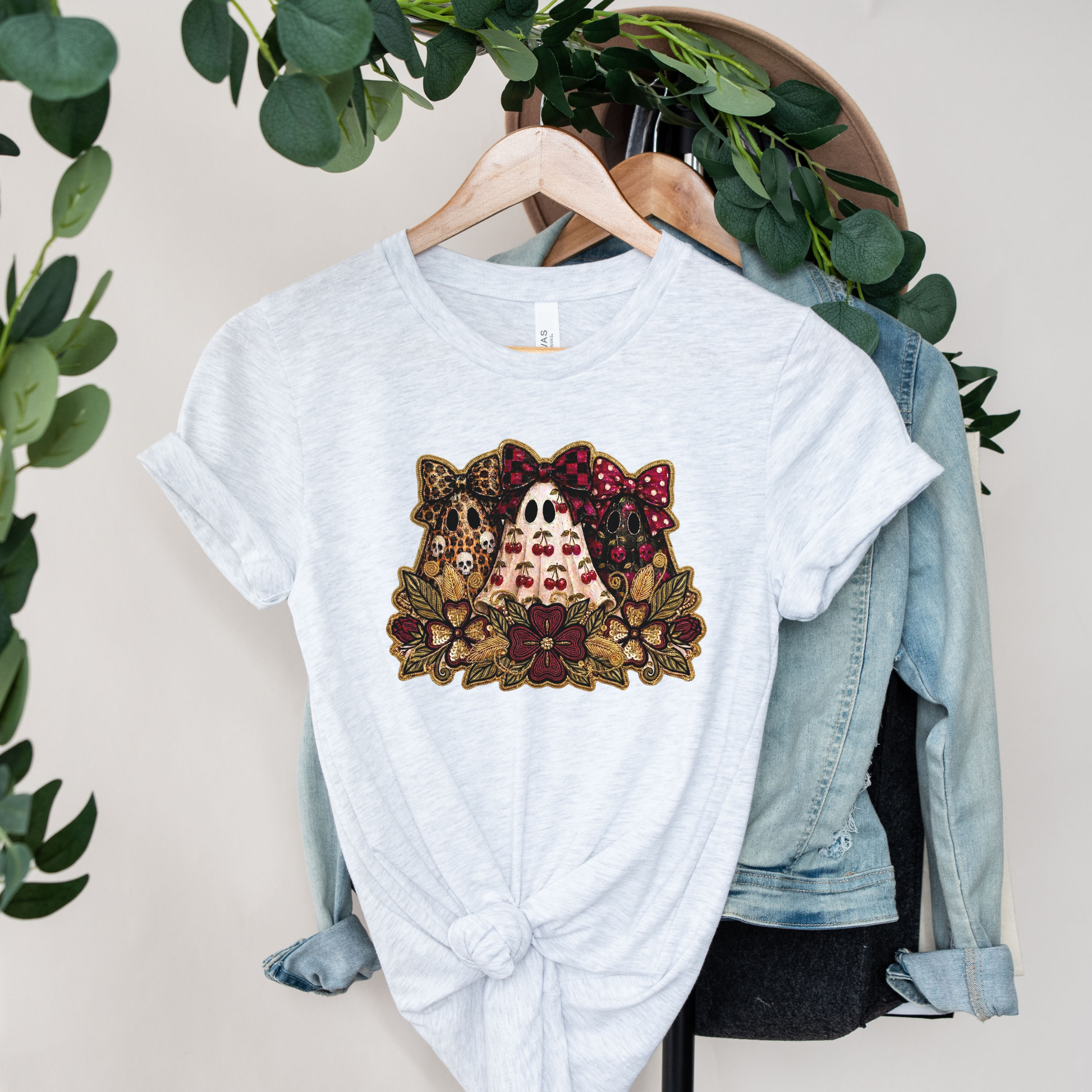 Cute Preppy Ghost Coquette Halloween Shirt featuring cherry, leopard, and floral bow ghosts with autumn florals. The perfect trendy fall graphic tee for pumpkin patch season and Halloween. preppy ghost shirt, coquette halloween shirt, cherry ghost shirt, cute halloween tee, ghost bow shirt, spooky season shirt, fall aesthetic shirt, pumpkin patch outfit, halloween graphic tee, floral ghost shirt, leopard bow ghost, autumn shirt, coquette fall shirt