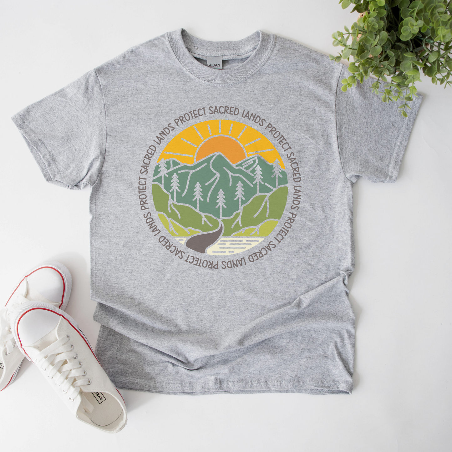 Protect Sacred Lands shirt featuring mountains, trees, water, and a rising sun surrounded by the words Protect Sacred Lands in a circular design. Protect Sacred Lands Shirt, Indigenous Advocacy Shirt, Environmental Awareness Shirt, Nature Conservation Apparel, Indigenous Land Stewardship, Protect The Land Shirt, Outdoor Graphic Tee, Conservation Clothing, Indigenous Ally Apparel, Nature Lover Gift