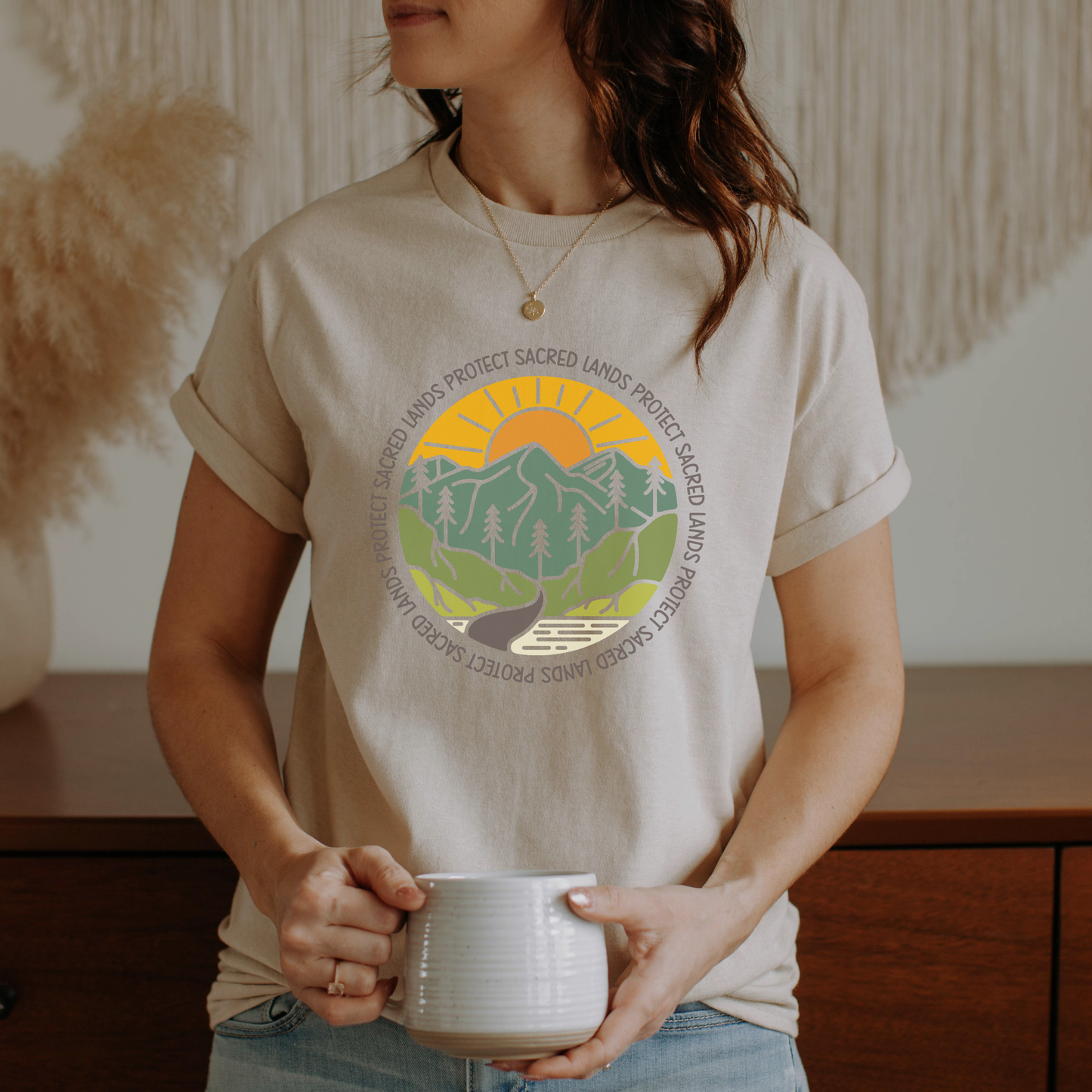 Protect Sacred Lands shirt featuring mountains, trees, water, and a rising sun surrounded by the words Protect Sacred Lands in a circular design. Protect Sacred Lands Shirt, Indigenous Advocacy Shirt, Environmental Awareness Shirt, Nature Conservation Apparel, Indigenous Land Stewardship, Protect The Land Shirt, Outdoor Graphic Tee, Conservation Clothing, Indigenous Ally Apparel, Nature Lover Gift