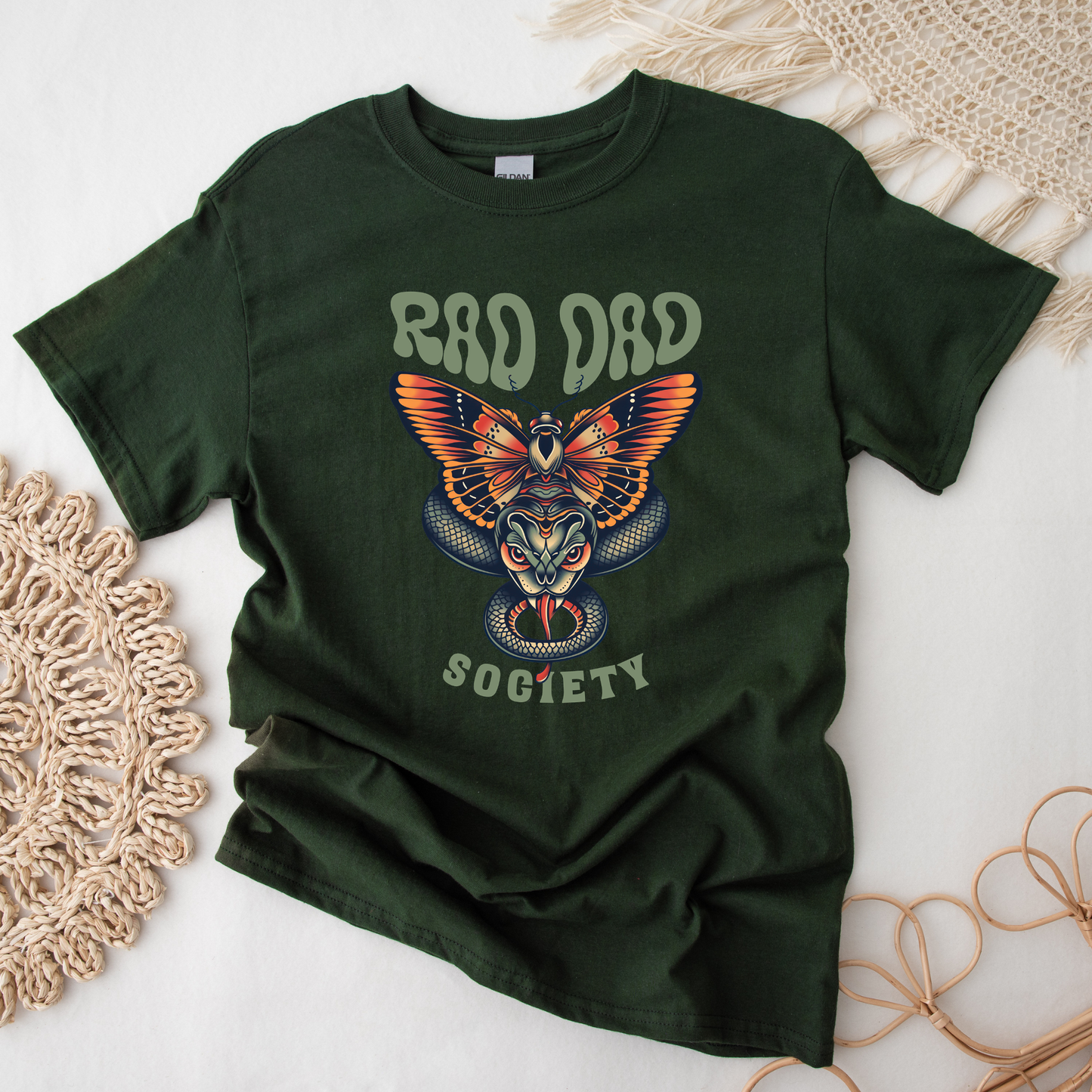 Rad Dad Society shirt with moth and snake graphic on a unisex t-shirt.rad dad society, dad shirt, graphic tee, retro dad shirt, unisex t-shirt, moth and snake design, cool dad shirt, father gift, bold dad apparel, vintage style tee, unique dad shirt, everyday casual shirt, statement graphic tee, father’s day gift, rad dad tee