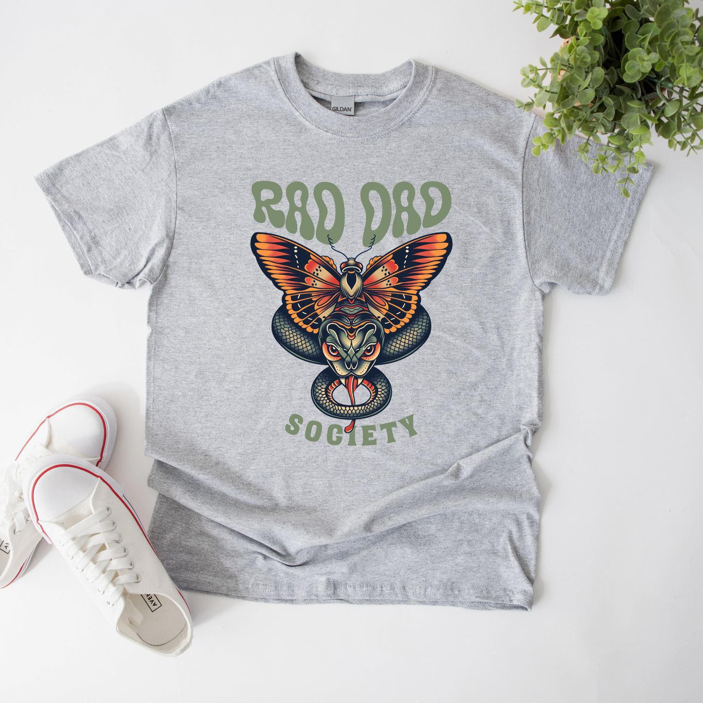 Rad Dad Society shirt with moth and snake graphic on a unisex t-shirt.rad dad society, dad shirt, graphic tee, retro dad shirt, unisex t-shirt, moth and snake design, cool dad shirt, father gift, bold dad apparel, vintage style tee, unique dad shirt, everyday casual shirt, statement graphic tee, father’s day gift, rad dad tee