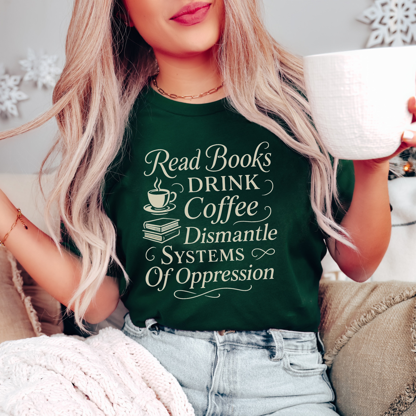 Person wearing a green t-shirt with motivational text, holding a mug. read books drink coffee dismantle systems of oppression shirt, activist shirt, book lover shirt, coffee lover tee, social justice shirt, political statement tee, feminist shirt, progressive apparel, reader shirt, library shirt, protest shirt, anti oppression shirt, unisex graphic tee, outspoken clothing, education and activism shirt