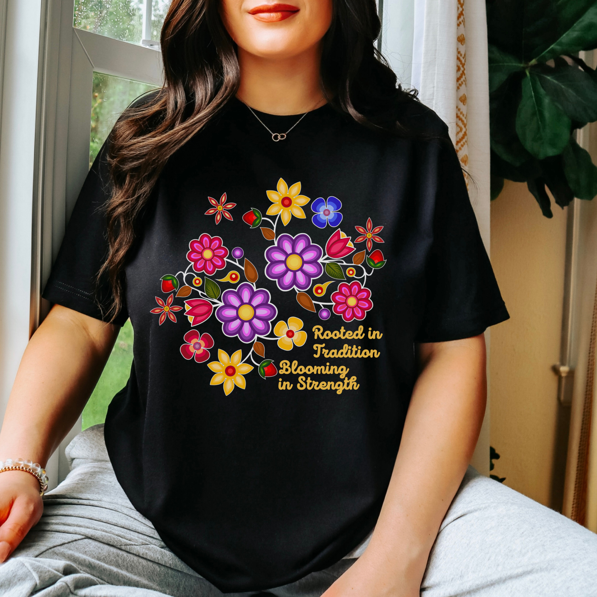 Rooted In Tradition Blooming In Strength shirt, Indigenous floral shirt, Indigenous inspired apparel, Indigenous owned clothing brand, Indigenous small business Canada, cultural graphic tee, floral graphic t-shirt, meaningful quote shirt, Sahdeh Spruce apparel, Indigenous pride clothing, Canadian Indigenous clothing brand, inspirational cultural shirt, made to order clothing, eco conscious apparel