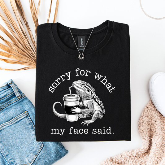 Sorry for what my face said shirt featuring a funny bearded dragon drinking from a cup on a unisex graphic tee. sorry for what my face said shirt, funny bearded dragon shirt, reptile lover tee, sarcastic graphic tee, dragon drinking cup shirt, unisex funny shirt, bearded dragon gift, quirky animal shirt, statement tee, humorous reptile apparel, casual funny tee, animal lover shirt, sarcastic quote shirt, dragon lover shirt, everyday graphic tee