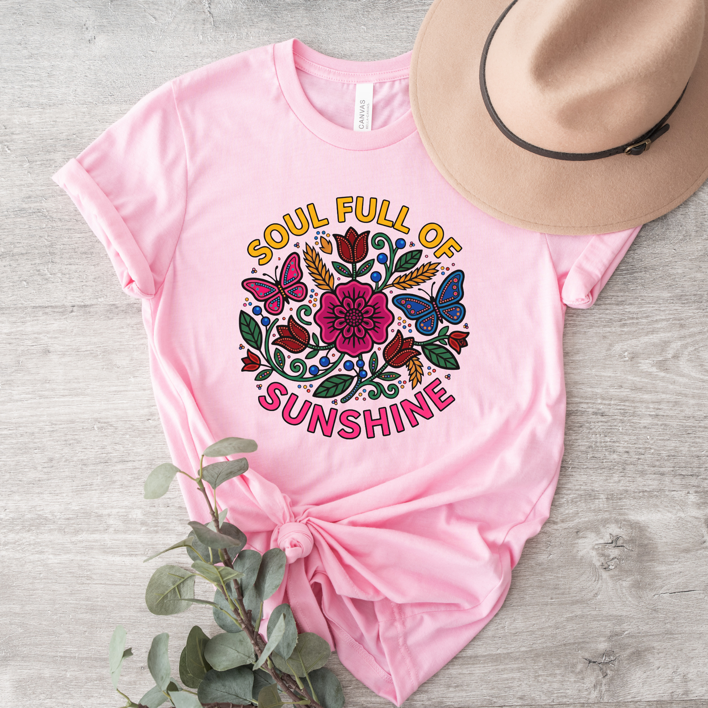 t-shirt featuring colorful Indigenous-inspired floral artwork, butterflies, and the phrase "Soul Full of Sunshine" in a vibrant circular design. soul full of sunshine shirt, Indigenous floral shirt, woodland floral shirt, butterfly shirt, floral graphic tee, colorful floral shirt, positive vibes shirt, sunshine shirt, Indigenous inspired apparel, nature lover shirt, boho floral tee, cottagecore shirt, botanical shirt, wildflower shirt, spring graphic tee, summer shirt, butterfly lover gift, floral aesthetic