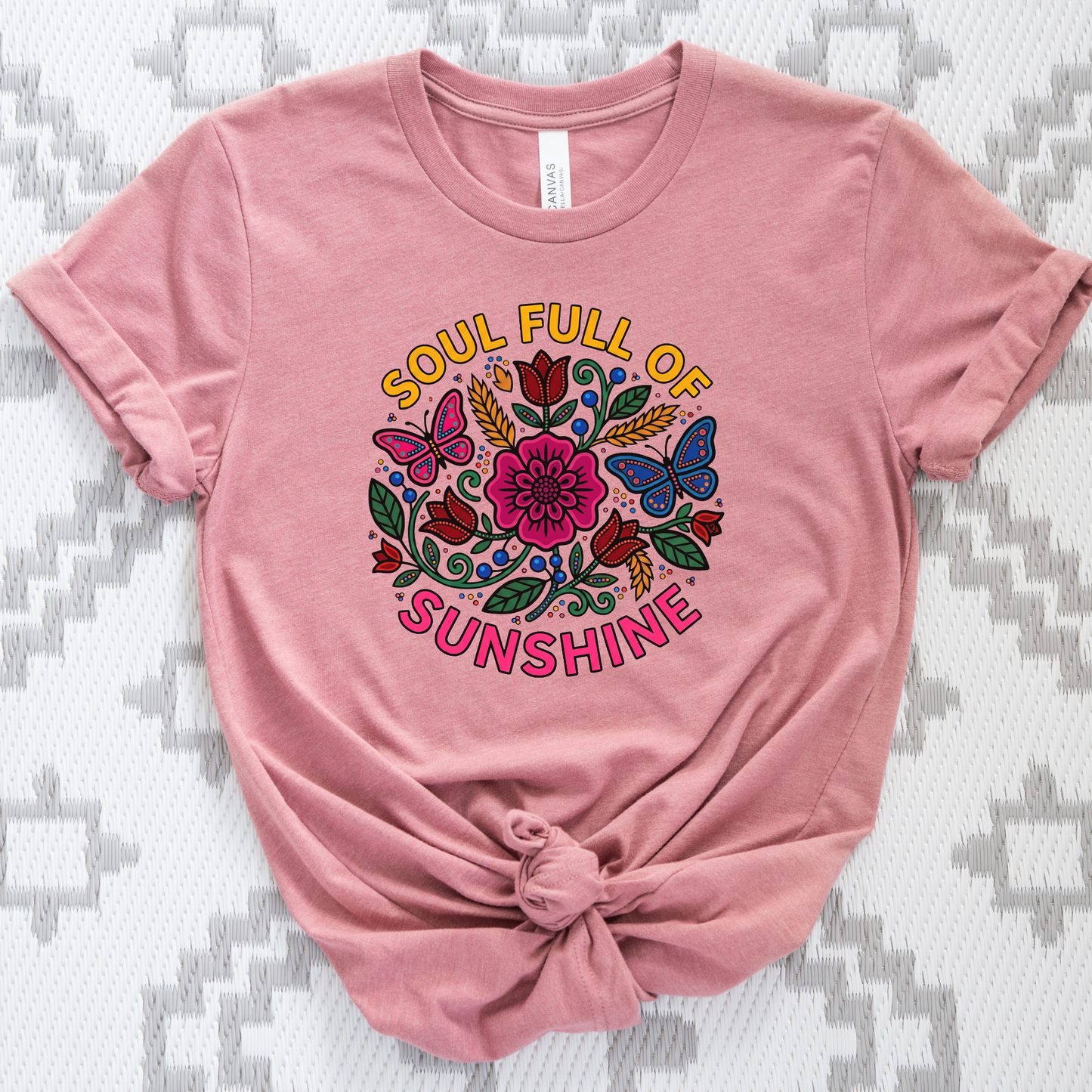 t-shirt featuring colorful Indigenous-inspired floral artwork, butterflies, and the phrase "Soul Full of Sunshine" in a vibrant circular design. soul full of sunshine shirt, Indigenous floral shirt, woodland floral shirt, butterfly shirt, floral graphic tee, colorful floral shirt, positive vibes shirt, sunshine shirt, Indigenous inspired apparel, nature lover shirt, boho floral tee, cottagecore shirt, botanical shirt, wildflower shirt, spring graphic tee, summer shirt, butterfly lover gift, floral aesthetic