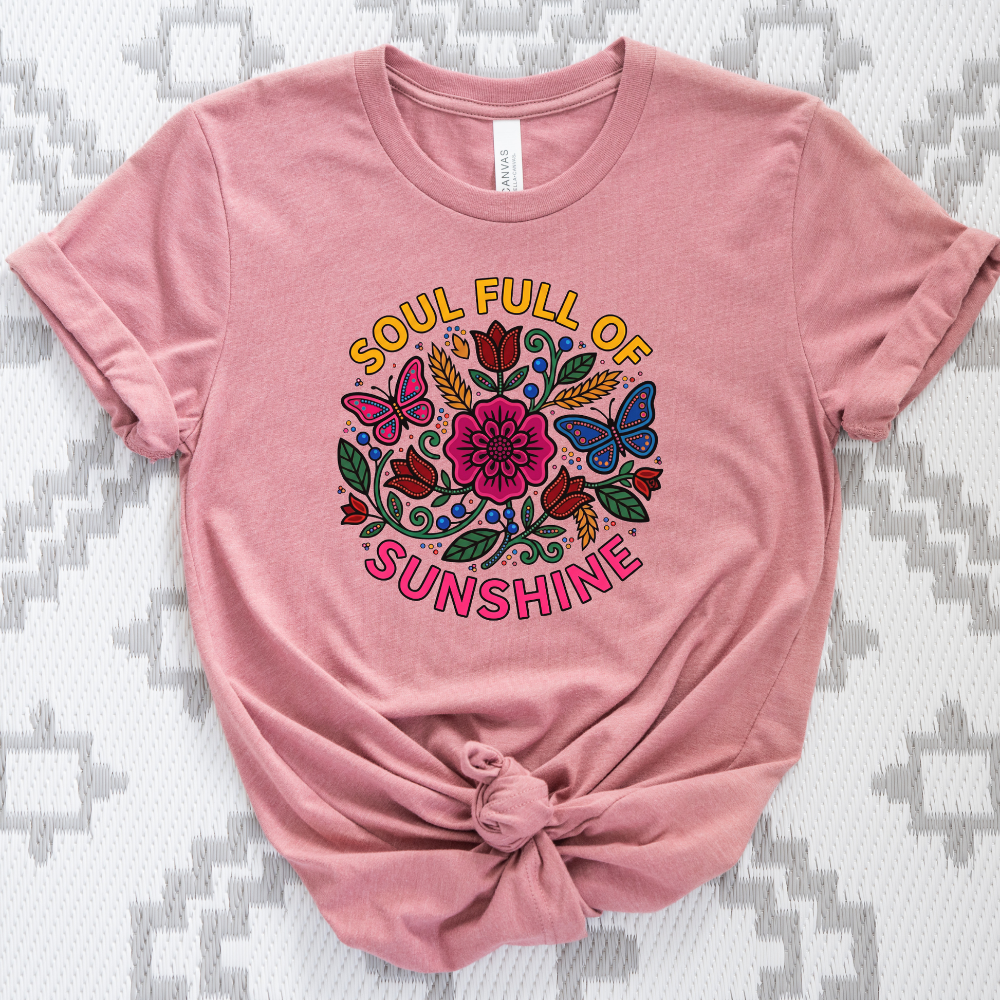 t-shirt featuring colorful Indigenous-inspired floral artwork, butterflies, and the phrase "Soul Full of Sunshine" in a vibrant circular design. soul full of sunshine shirt, Indigenous floral shirt, woodland floral shirt, butterfly shirt, floral graphic tee, colorful floral shirt, positive vibes shirt, sunshine shirt, Indigenous inspired apparel, nature lover shirt, boho floral tee, cottagecore shirt, botanical shirt, wildflower shirt, spring graphic tee, summer shirt, butterfly lover gift, floral aesthetic