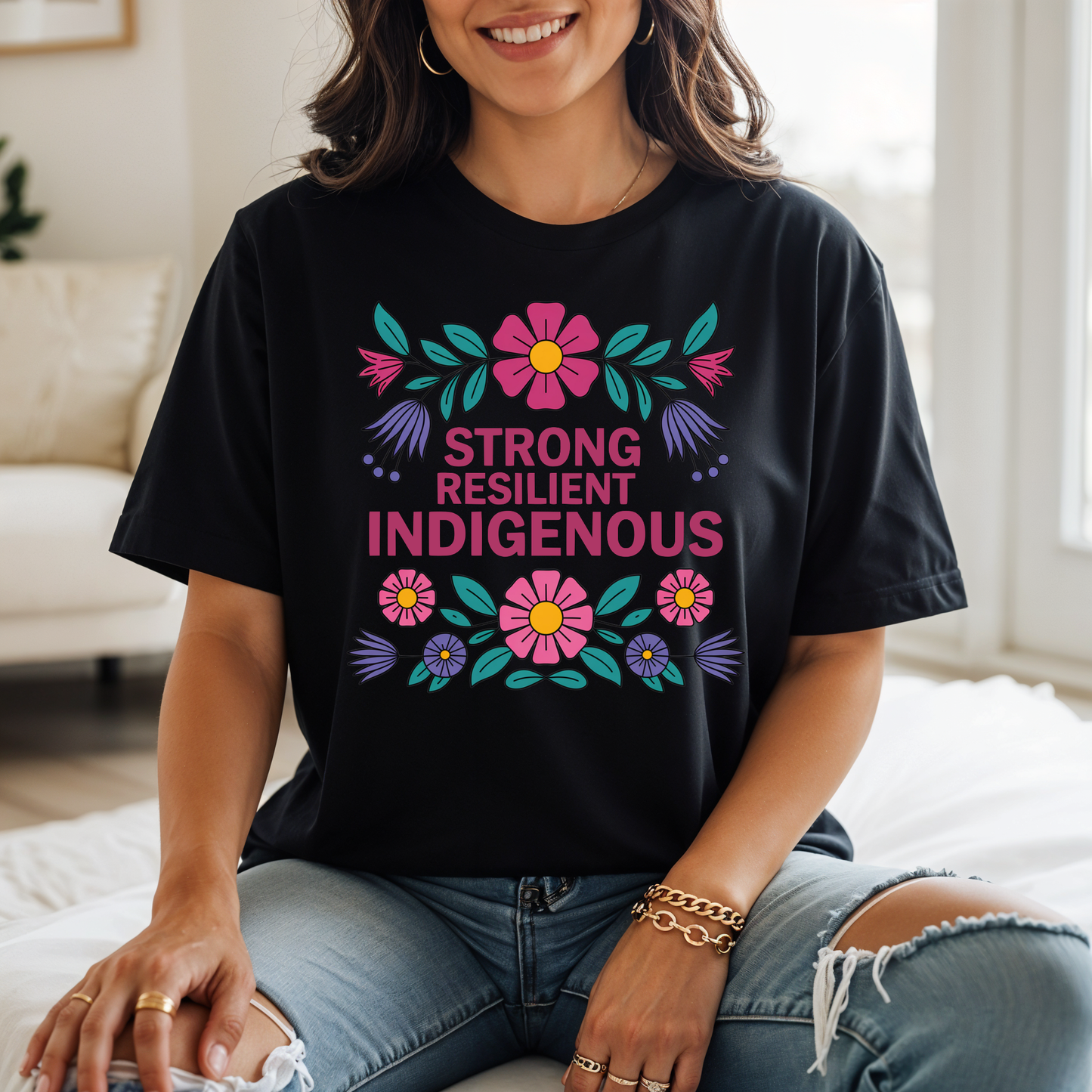 black t-shirt with colorful floral design that says strong resilient indigenous, strong resilient indigenous t-shirt, indigenous floral tee, resilience graphic shirt, indigenous empowerment apparel, floral indigenous design, unisex indigenous shirt, sahdeh spruce clothing, indigenous pride t-shirt, native resilience tee, indigenous artist design, cultural strength shirt, heritage graphic apparel