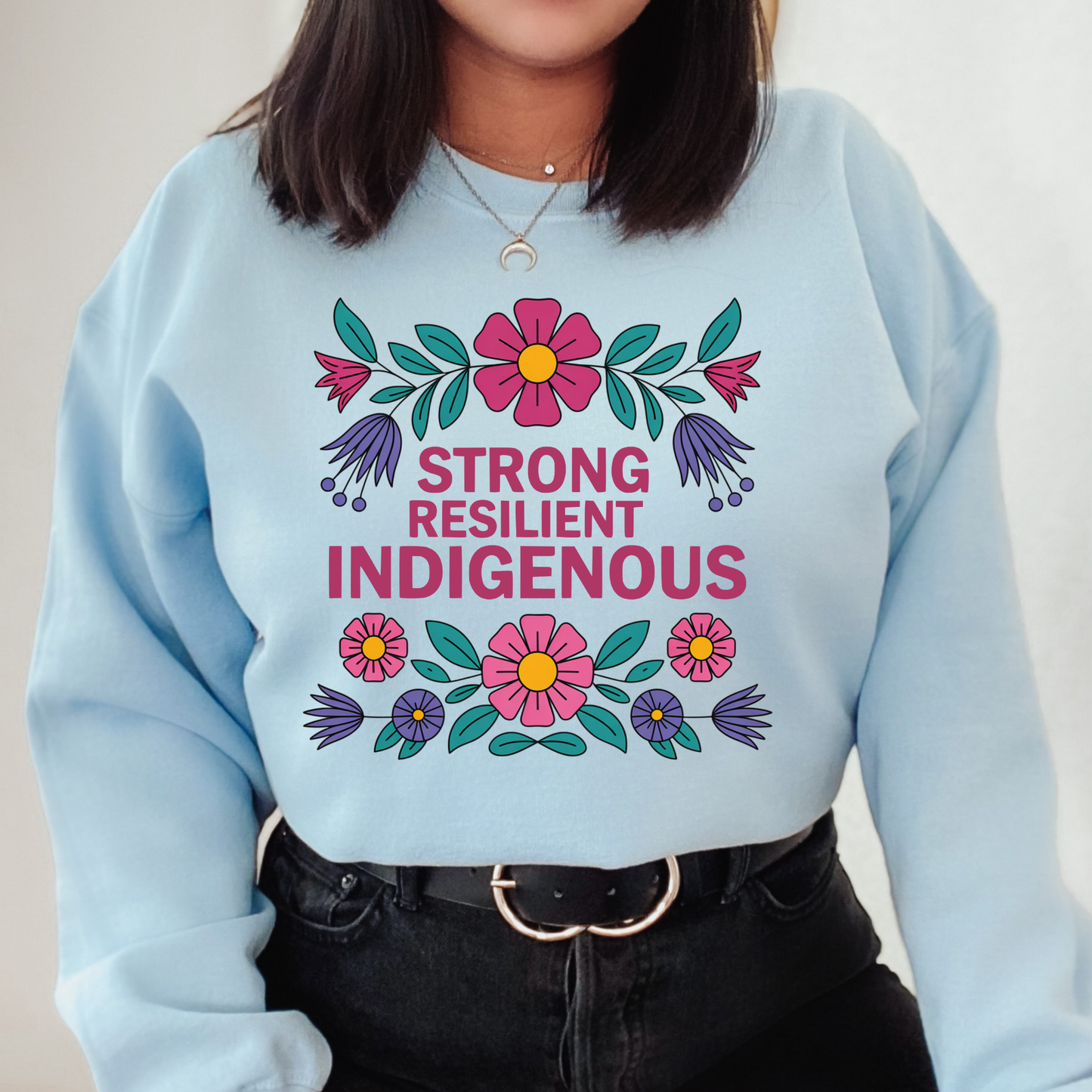 blue sweatshirt with floral design and text 'Strong Resilient Indigenous' strong resilient indigenous sweatshirt, indigenous floral crewneck, resilience sweatshirt indigenous, floral indigenous hoodie alternative, unisex indigenous sweatshirt, sahdeh spruce sweatshirts, indigenous pride pullover, native resilience fleece, indigenous artist sweatshirt, cultural strength crewneck, empowerment floral sweatshirt