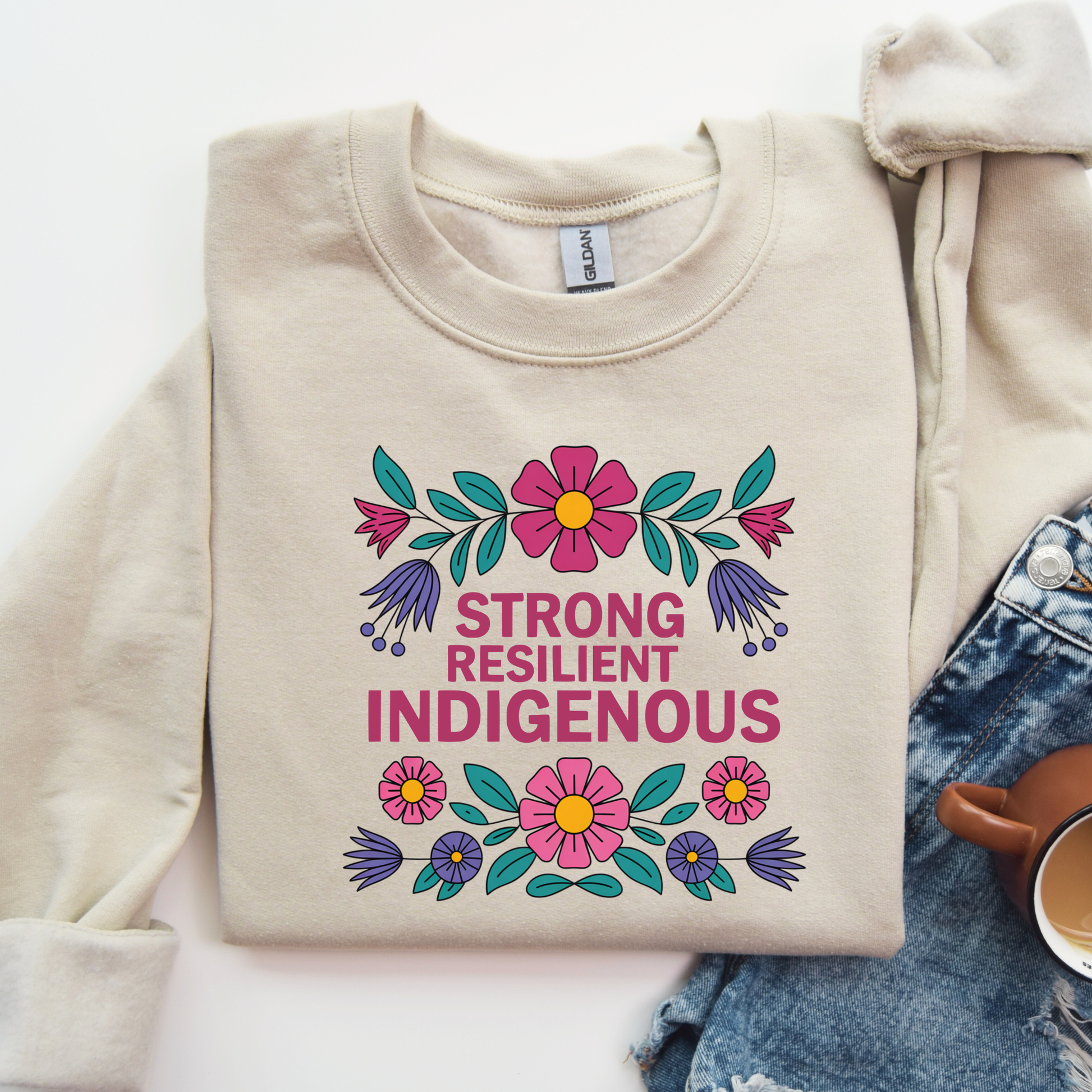 sand sweatshirt with floral design and text 'Strong Resilient Indigenous' strong resilient indigenous sweatshirt, indigenous floral crewneck, resilience sweatshirt indigenous, floral indigenous hoodie alternative, unisex indigenous sweatshirt, sahdeh spruce sweatshirts, indigenous pride pullover, native resilience fleece, indigenous artist sweatshirt, cultural strength crewneck, empowerment floral sweatshirt