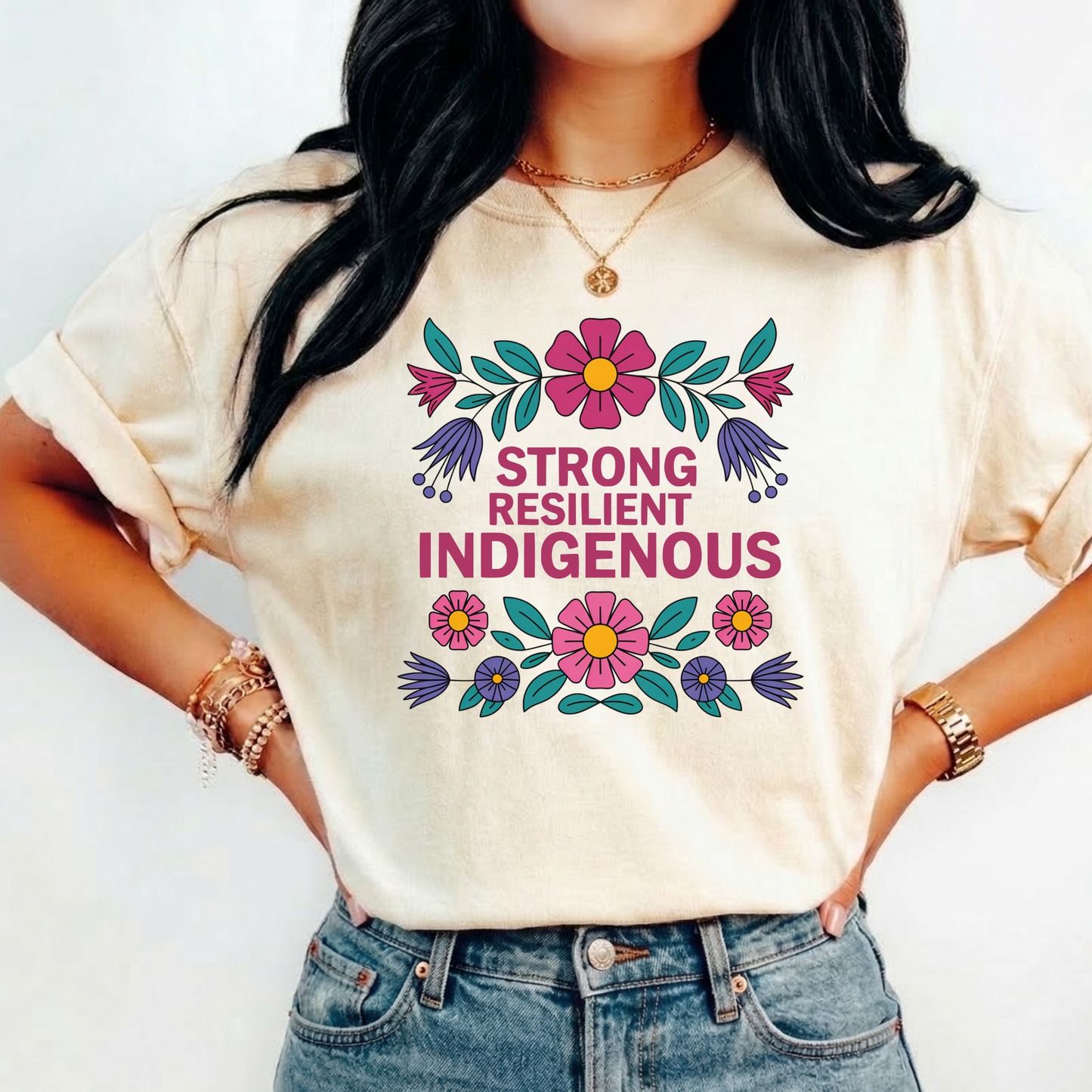 natural t-shirt with colorful floral design that says strong resilient indigenous, strong resilient indigenous t-shirt, indigenous floral tee, resilience graphic shirt, indigenous empowerment apparel, floral indigenous design, unisex indigenous shirt, sahdeh spruce clothing, indigenous pride t-shirt, native resilience tee, indigenous artist design, cultural strength shirt, heritage graphic apparel