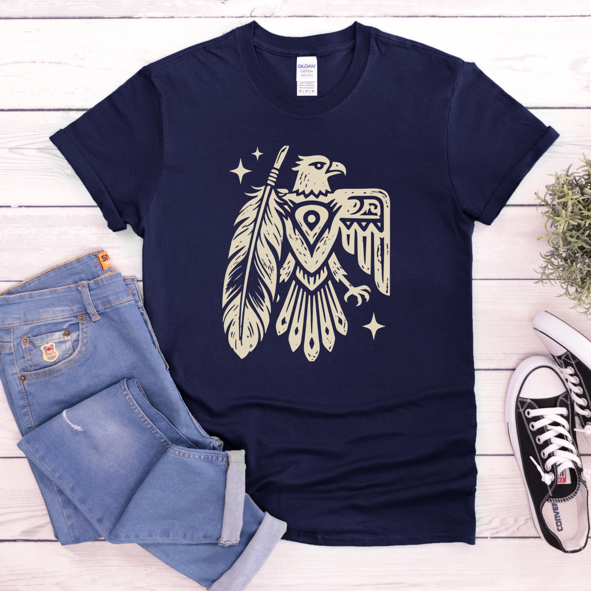 Thunderbird Feather graphic t-shirt featuring a cream-colored bird and feather illustration on a shirt. Thunderbird Shirt, Feather Shirt, Eagle Graphic Tee, Indigenous Inspired, Nature Shirt, Forest Green Tee, Graphic T-Shirt, Symbolic Art, Outdoor Apparel, Cultural Apparel, Unisex Shirt, Wilderness Style, Native Inspired Art, Bird Graphic Shirt, Heritage Design, Statement Tee, Gift For Nature Lover, Outdoor Lifestyle, Spiritual Symbolism, Casual Graphic Tee