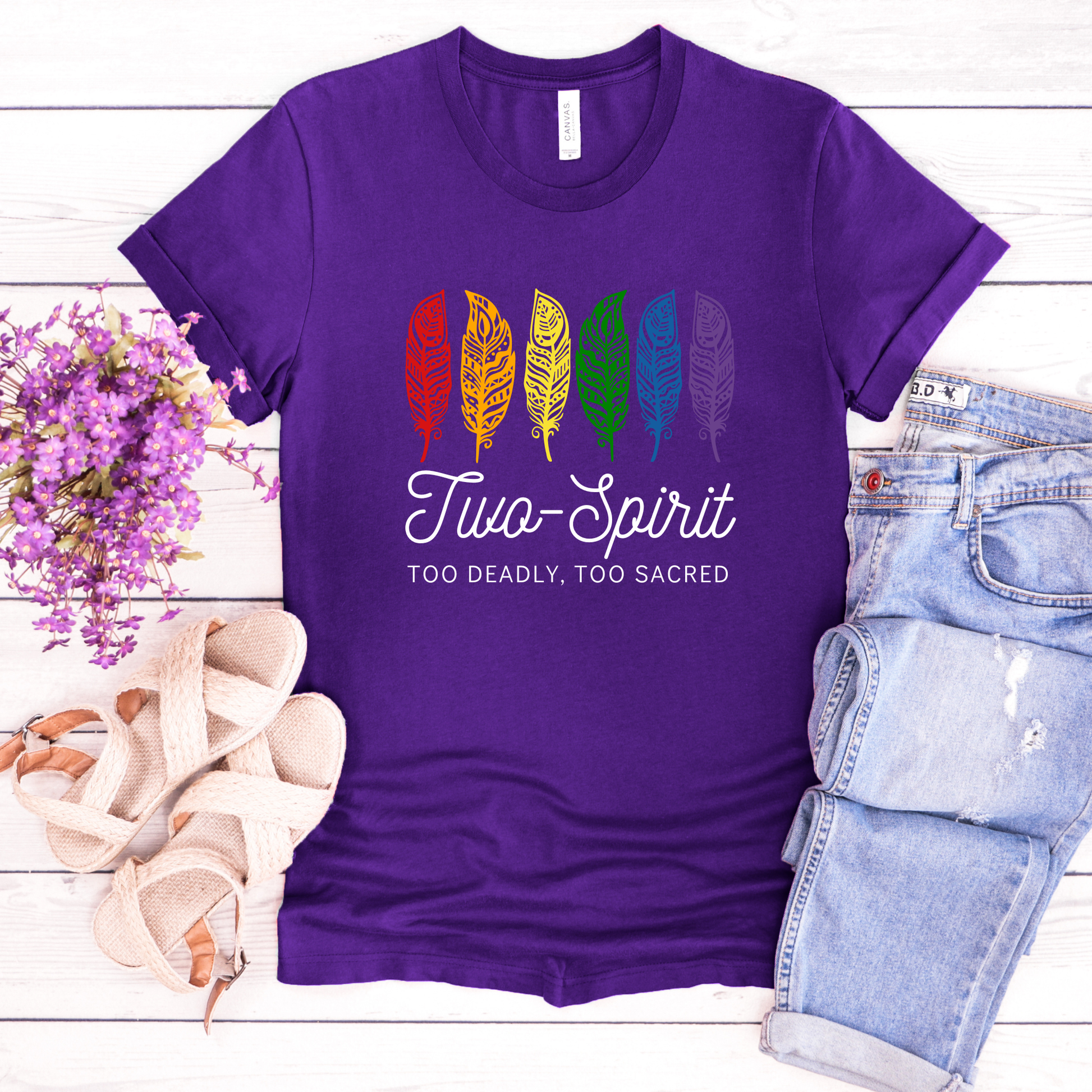 Two-Spirit Too Deadly, Too Sacred shirt with rainbow feather graphic and bold Indigenous Pride text on a unisex tee. Two-Spirit shirt, Two Spirit pride, Indigenous pride shirt, Too deadly too sacred, rainbow feather shirt, Indigenous LGBTQ tee, unisex graphic tee, Pride shirt, Two Spirit apparel, statement tee, cultural pride shirt, Indigenous owned brand, visibility shirt, sacred identity, LGBTQ Indigenous shirt