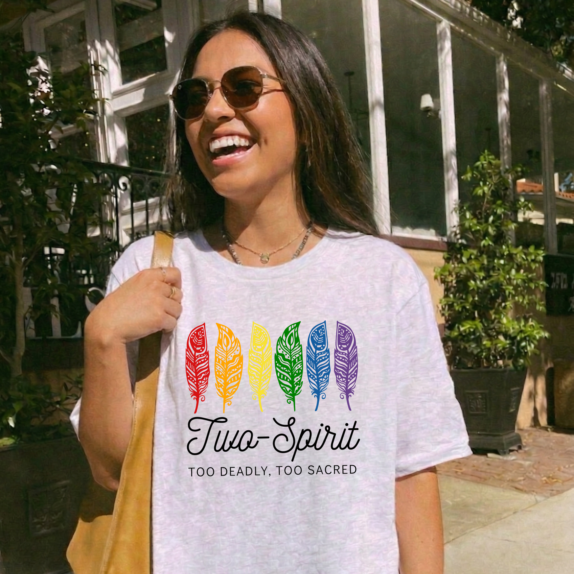 Two-Spirit Too Deadly, Too Sacred shirt with rainbow feather graphic and bold Indigenous Pride text on a unisex tee. Two-Spirit shirt, Two Spirit pride, Indigenous pride shirt, Too deadly too sacred, rainbow feather shirt, Indigenous LGBTQ tee, unisex graphic tee, Pride shirt, Two Spirit apparel, statement tee, cultural pride shirt, Indigenous owned brand, visibility shirt, sacred identity, LGBTQ Indigenous shirt
