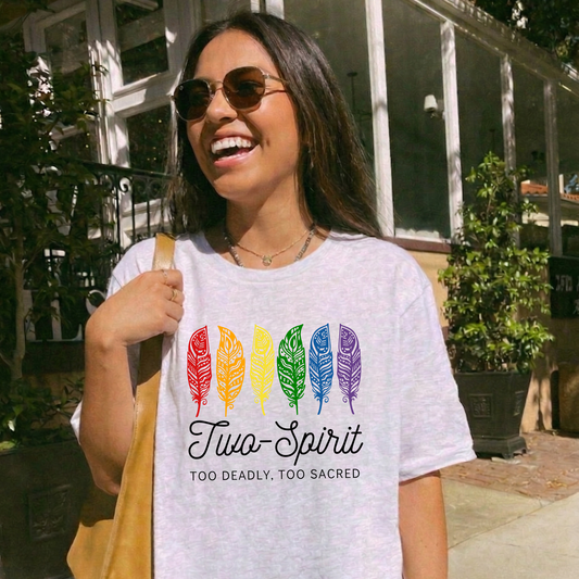 Two-Spirit Too Deadly, Too Sacred shirt with rainbow feather graphic and bold Indigenous Pride text on a unisex tee. Two-Spirit shirt, Two Spirit pride, Indigenous pride shirt, Too deadly too sacred, rainbow feather shirt, Indigenous LGBTQ tee, unisex graphic tee, Pride shirt, Two Spirit apparel, statement tee, cultural pride shirt, Indigenous owned brand, visibility shirt, sacred identity, LGBTQ Indigenous shirt