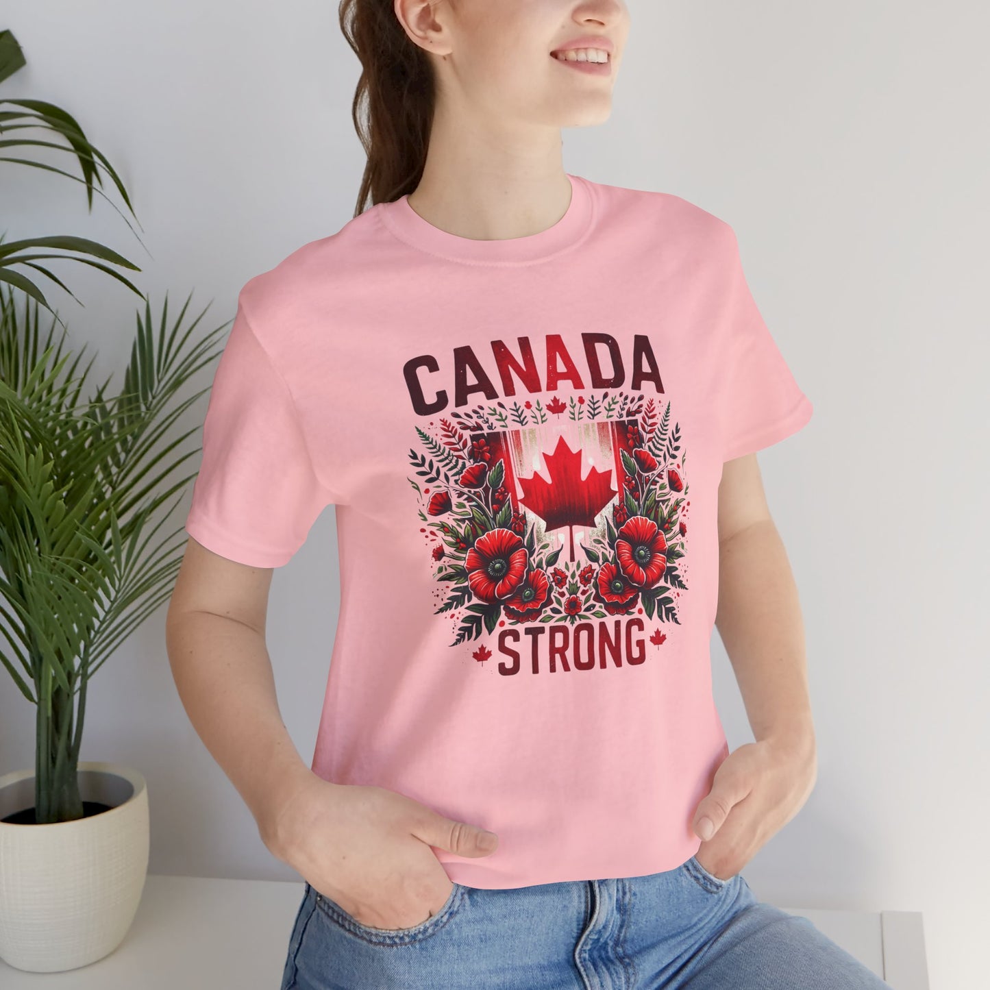 Canada Strong shirt featuring a red Canadian maple leaf surrounded by vibrant red flowers and greenery with bold Canada Strong text. Proudly made in Canada, this patriotic floral graphic tee celebrates Canadian pride, resilience, and unity.