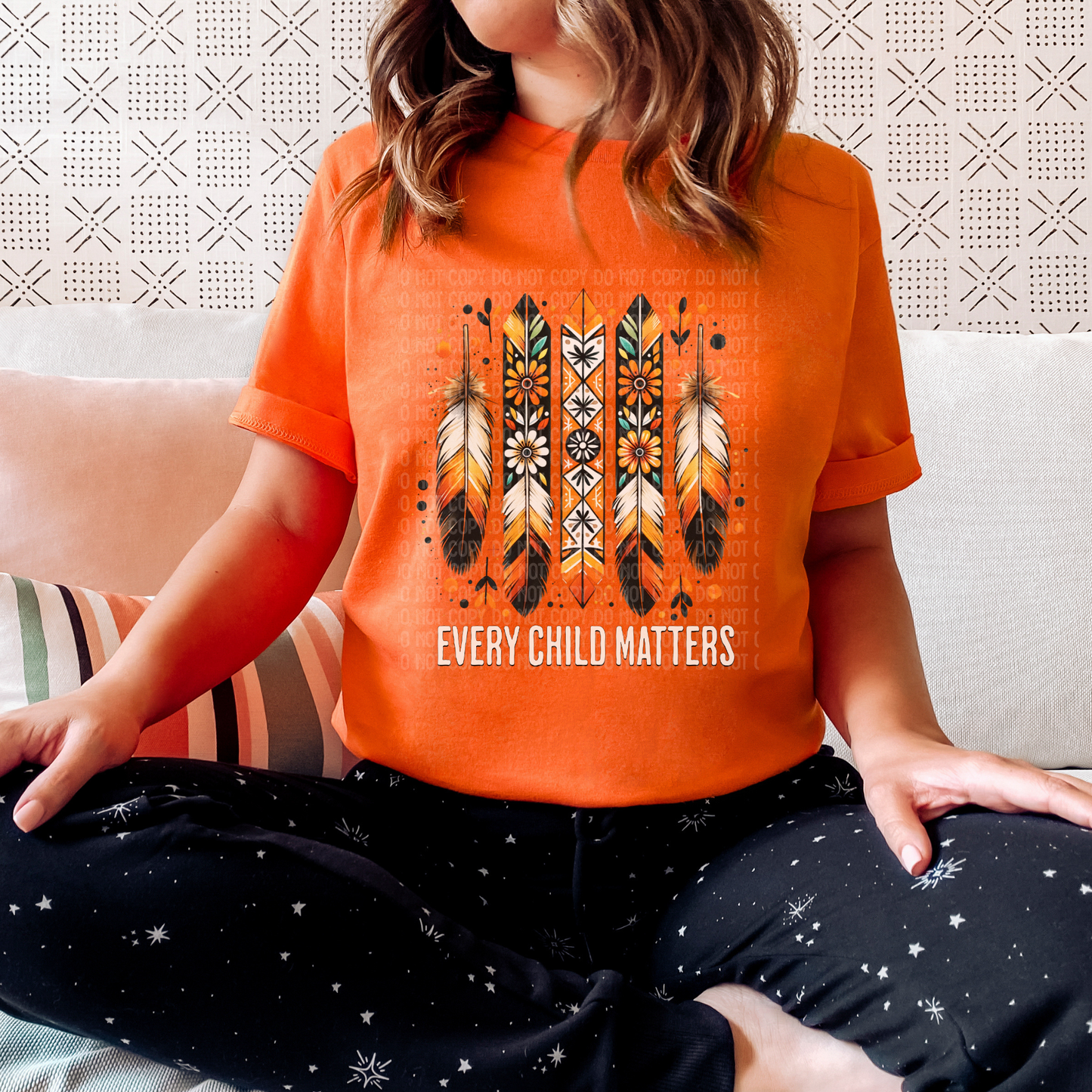 Person wearing an orange t-shirt with feather design and 'Every Child Matters' text, sitting on a couch. Every Child Matters shirt, Orange Shirt Day, Indigenous awareness tee, reconciliation shirt, unisex graphic tee, remembrance shirt, Indigenous support, awareness apparel, statement tee, truth and reconciliation, Indigenous children, healing shirt, advocacy shirt, educational tee, Indigenous owned brand