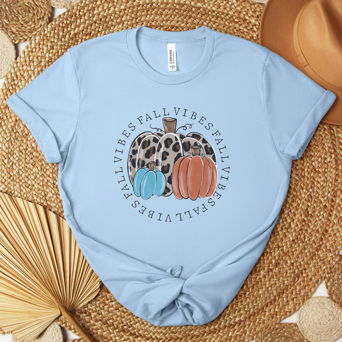 t-shirt featuring decorative pumpkins in autumn colors surrounded by circular "Fall Vibes" text, creating a cozy seasonal design perfect for fall lovers. fall vibes shirt, autumn pumpkin shirt, fall aesthetic t-shirt, pumpkin patch outfit, cozy autumn apparel, pumpkin lover tee, fall festival shirt, thanksgiving clothing, sweater weather shirt, autumn graphic tee, rustic fall fashion, pumpkin spice season apparel, cute fall shirt, fall lover gift, cozy season clothing
