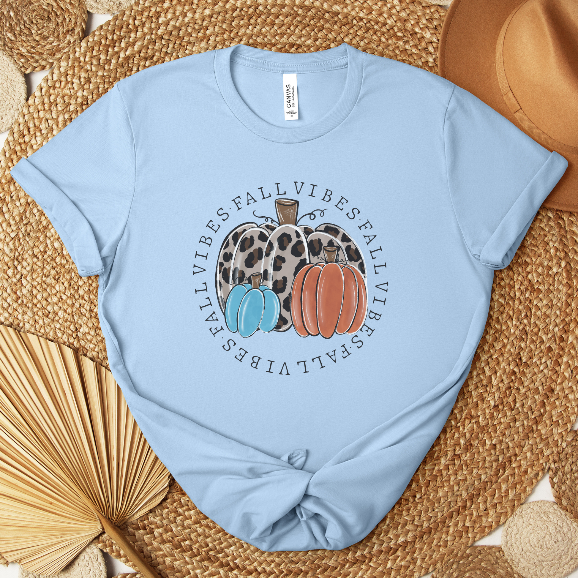 t-shirt featuring decorative pumpkins in autumn colors surrounded by circular "Fall Vibes" text, creating a cozy seasonal design perfect for fall lovers. fall vibes shirt, autumn pumpkin shirt, fall aesthetic t-shirt, pumpkin patch outfit, cozy autumn apparel, pumpkin lover tee, fall festival shirt, thanksgiving clothing, sweater weather shirt, autumn graphic tee, rustic fall fashion, pumpkin spice season apparel, cute fall shirt, fall lover gift, cozy season clothing