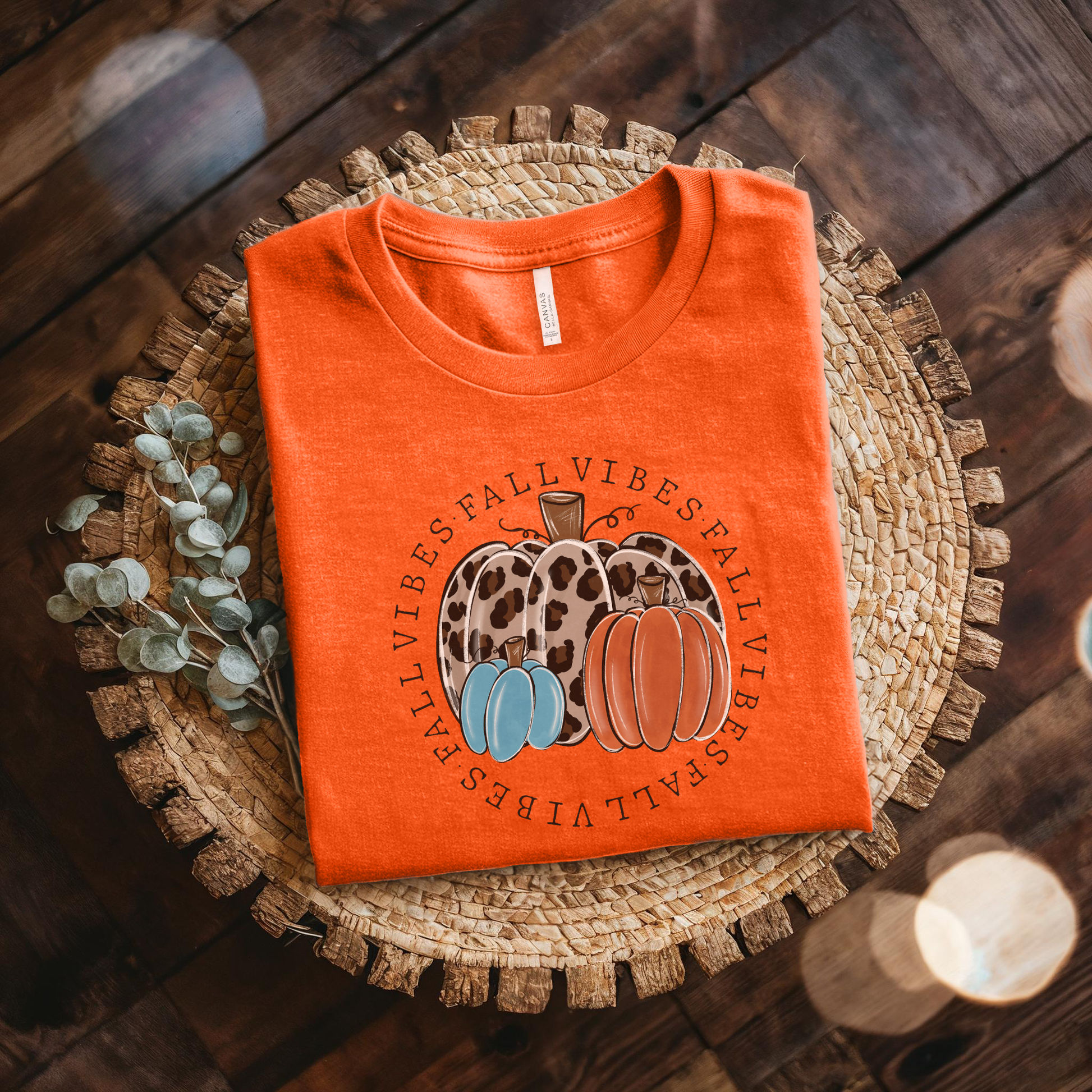 t-shirt featuring decorative pumpkins in autumn colors surrounded by circular "Fall Vibes" text, creating a cozy seasonal design perfect for fall lovers. fall vibes shirt, autumn pumpkin shirt, fall aesthetic t-shirt, pumpkin patch outfit, cozy autumn apparel, pumpkin lover tee, fall festival shirt, thanksgiving clothing, sweater weather shirt, autumn graphic tee, rustic fall fashion, pumpkin spice season apparel, cute fall shirt, fall lover gift, cozy season clothing