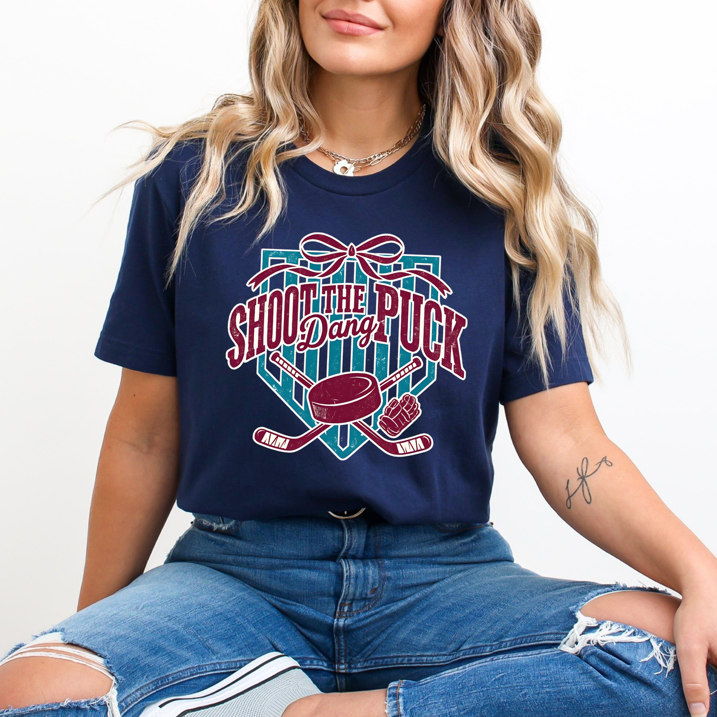 shoot the puck shirt, hockey graphic tee, coquette hockey shirt, hockey bow shirt, trendy hockey shirt, hockey mom shirt, hockey fan shirt, cute hockey shirt, aesthetic hockey tee, hockey sticks shirt, puck shirt, game day hockey outfit, sporty chic shirt, womens hockey shirt, unisex hockey tee
