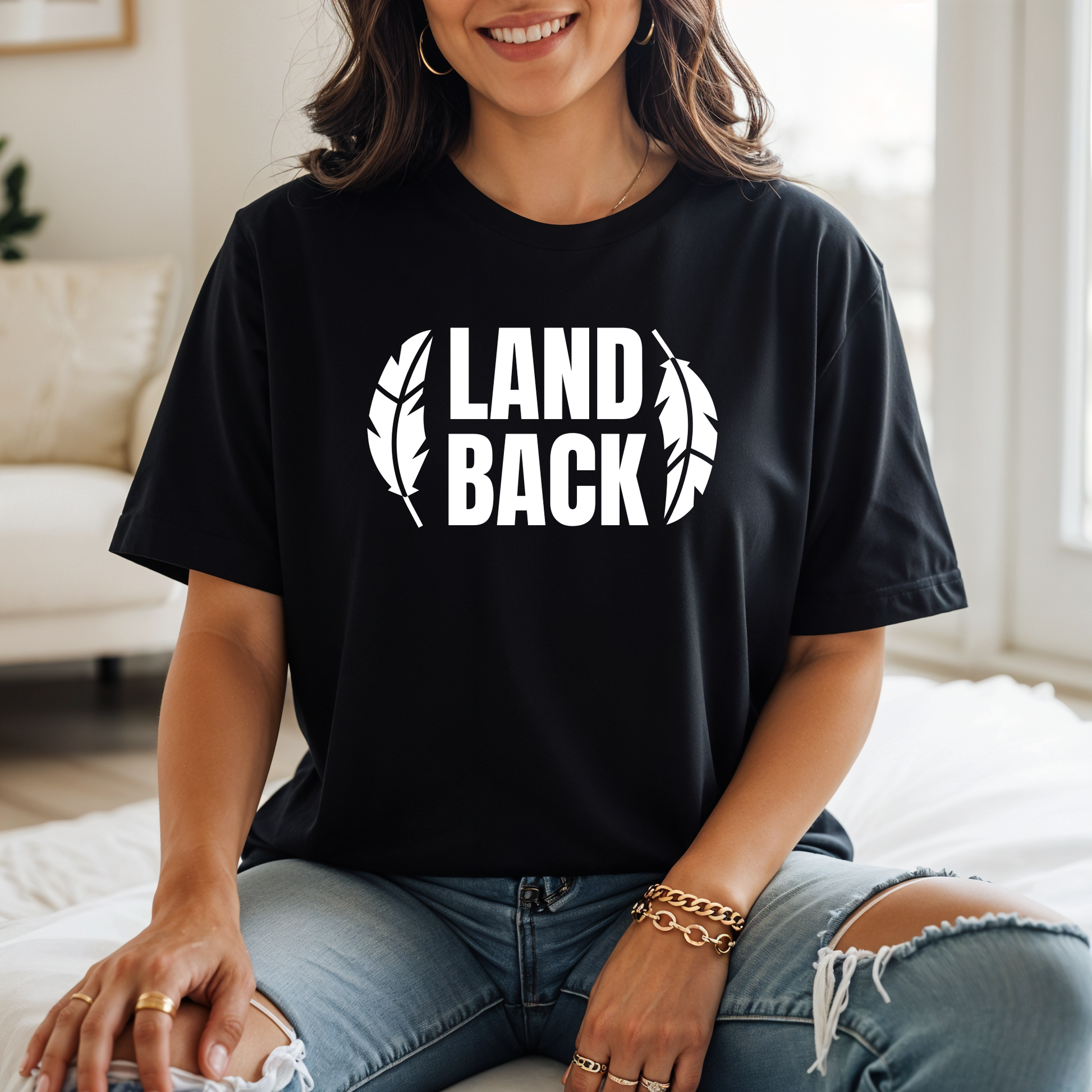 Land Back shirt featuring bold white lettering framed by two feathers, representing Indigenous sovereignty and Indigenous rights.land back shirt, indigenous shirt, indigenous rights shirt, indigenous sovereignty shirt, land back movement, decolonization shirt, indigenous advocacy apparel, indigenous activist shirt, truth and reconciliation shirt, orange shirt day apparel, national indigenous peoples day shirt, indigenous pride shirt, ally shirt, feather shirt, indigenous graphic tee, native rights shirt