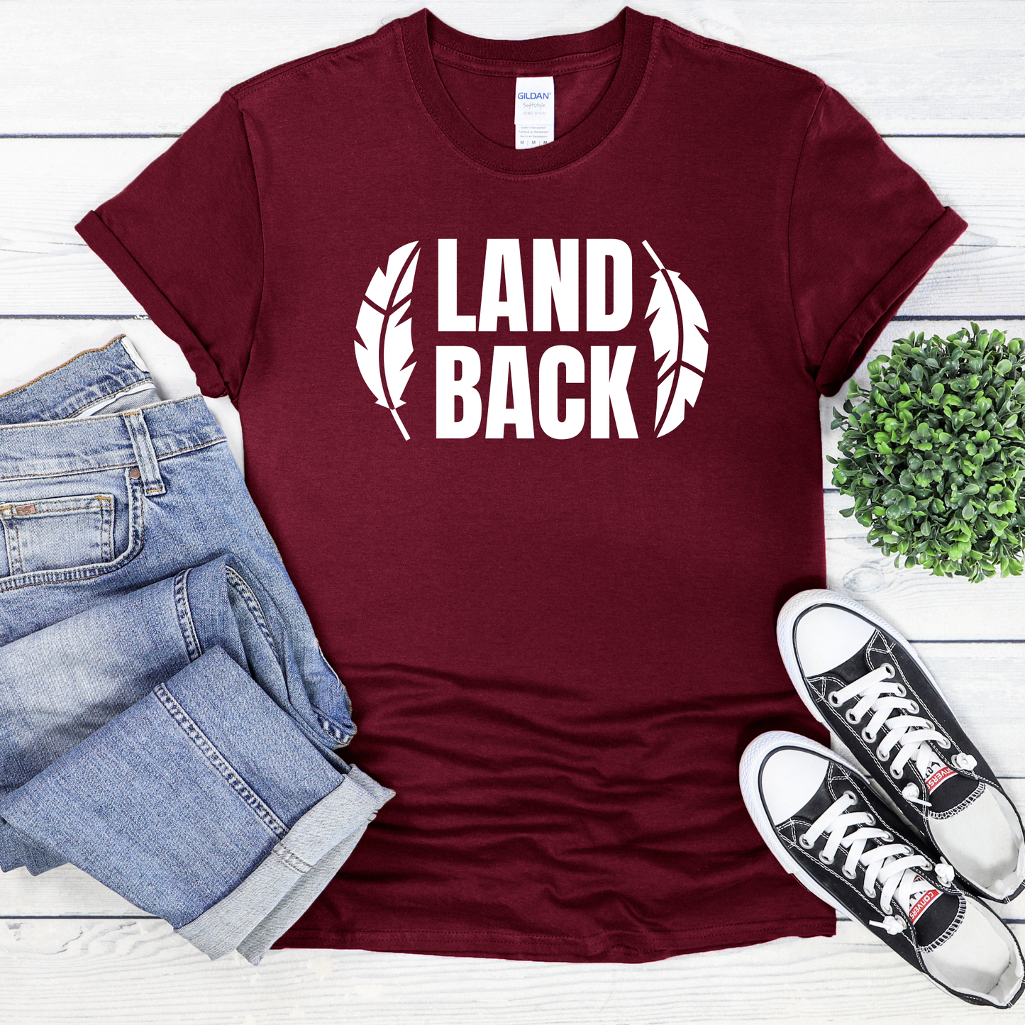 Land Back shirt featuring bold white lettering framed by two feathers, representing Indigenous sovereignty and Indigenous rights.land back shirt, indigenous shirt, indigenous rights shirt, indigenous sovereignty shirt, land back movement, decolonization shirt, indigenous advocacy apparel, indigenous activist shirt, truth and reconciliation shirt, orange shirt day apparel, national indigenous peoples day shirt, indigenous pride shirt, ally shirt, feather shirt, indigenous graphic tee, native rights shirt