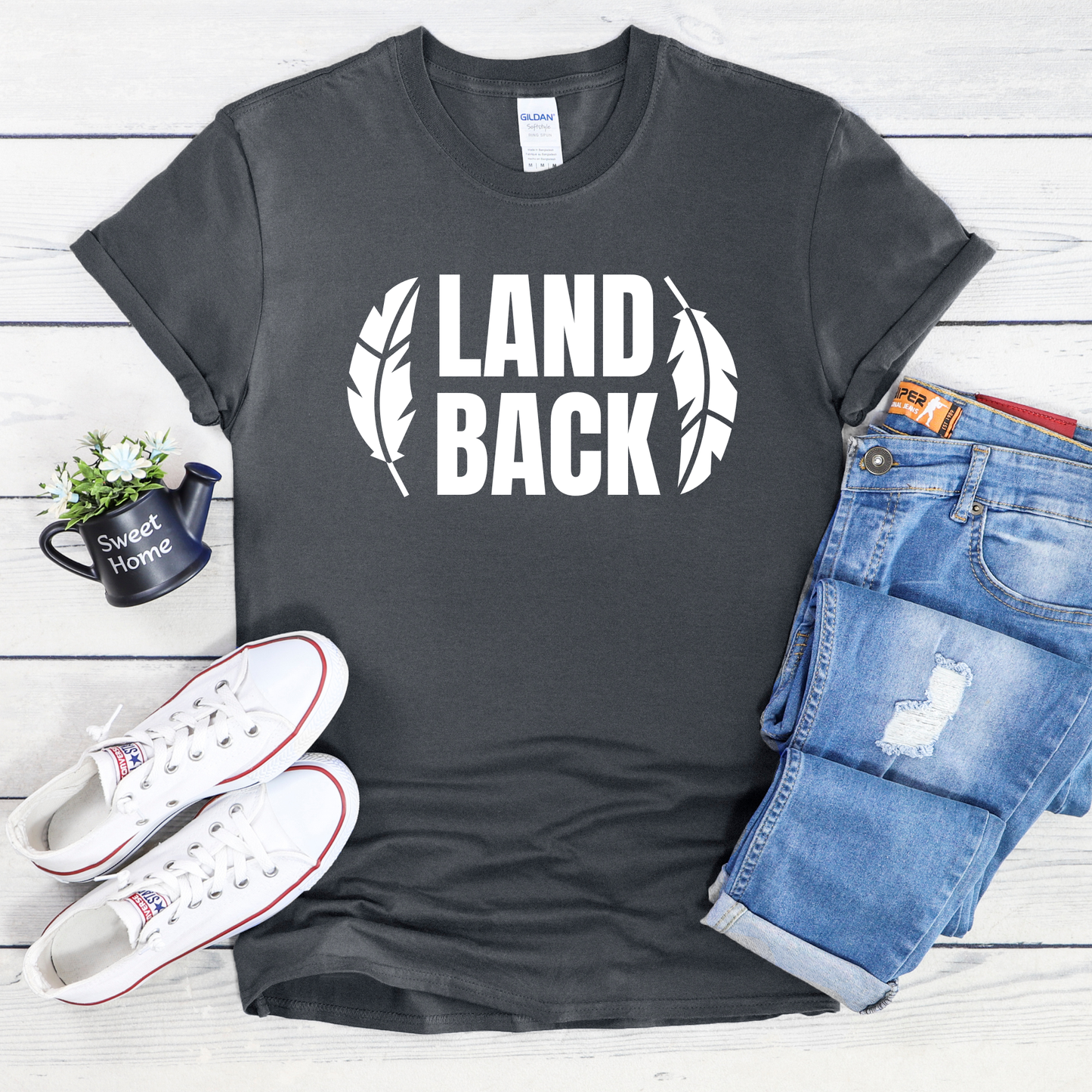 Land Back shirt featuring bold white lettering framed by two feathers, representing Indigenous sovereignty and Indigenous rights.land back shirt, indigenous shirt, indigenous rights shirt, indigenous sovereignty shirt, land back movement, decolonization shirt, indigenous advocacy apparel, indigenous activist shirt, truth and reconciliation shirt, orange shirt day apparel, national indigenous peoples day shirt, indigenous pride shirt, ally shirt, feather shirt, indigenous graphic tee, native rights shirt