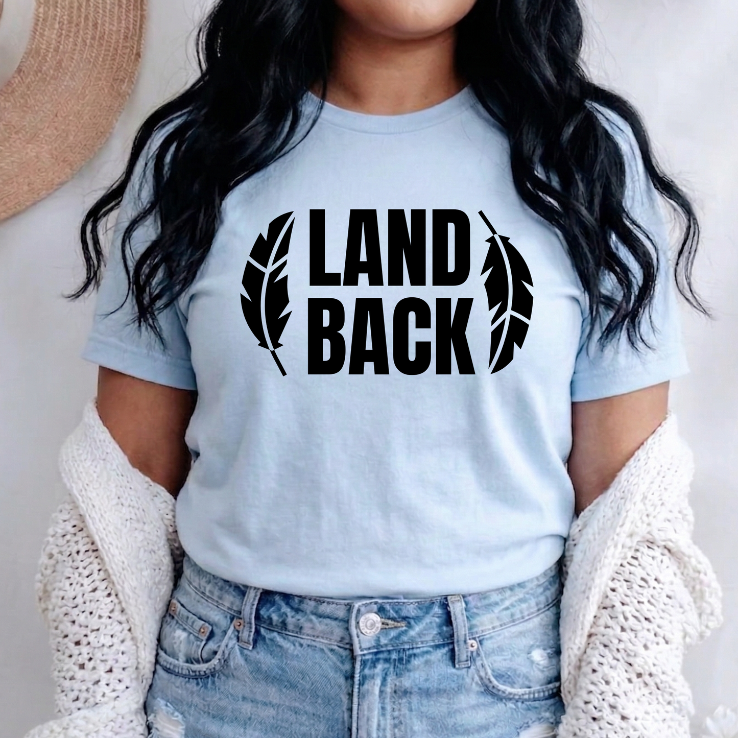 Land Back shirt featuring bold white lettering framed by two feathers, representing Indigenous sovereignty and Indigenous rights.land back shirt, indigenous shirt, indigenous rights shirt, indigenous sovereignty shirt, land back movement, decolonization shirt, indigenous advocacy apparel, indigenous activist shirt, truth and reconciliation shirt, orange shirt day apparel, national indigenous peoples day shirt, indigenous pride shirt, ally shirt, feather shirt, indigenous graphic tee, native rights shirt