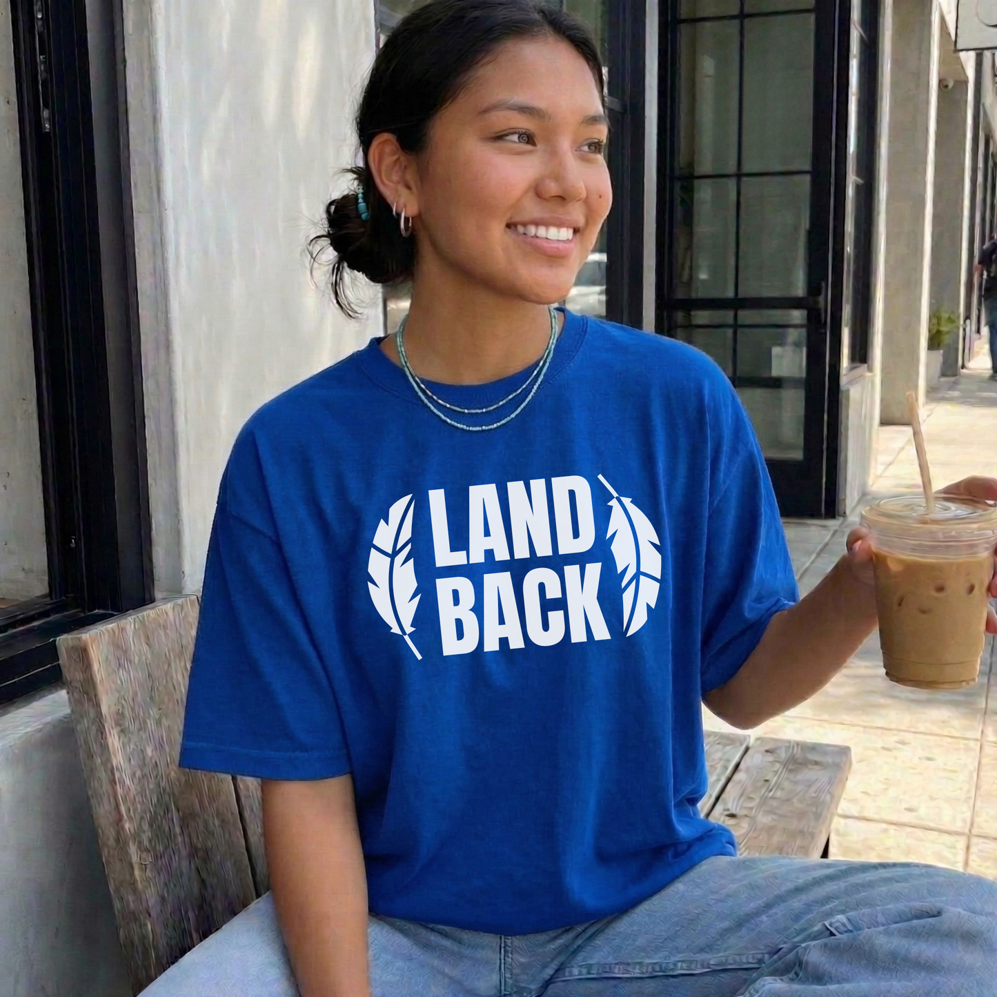 Land Back shirt featuring bold white lettering framed by two feathers, representing Indigenous sovereignty and Indigenous rights.land back shirt, indigenous shirt, indigenous rights shirt, indigenous sovereignty shirt, land back movement, decolonization shirt, indigenous advocacy apparel, indigenous activist shirt, truth and reconciliation shirt, orange shirt day apparel, national indigenous peoples day shirt, indigenous pride shirt, ally shirt, feather shirt, indigenous graphic tee, native rights shirt