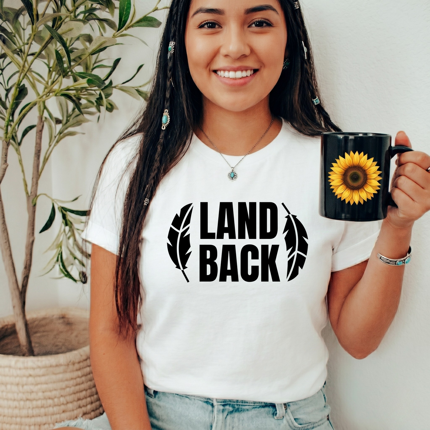 Land Back shirt featuring bold white lettering framed by two feathers, representing Indigenous sovereignty and Indigenous rights.land back shirt, indigenous shirt, indigenous rights shirt, indigenous sovereignty shirt, land back movement, decolonization shirt, indigenous advocacy apparel, indigenous activist shirt, truth and reconciliation shirt, orange shirt day apparel, national indigenous peoples day shirt, indigenous pride shirt, ally shirt, feather shirt, indigenous graphic tee, native rights shirt