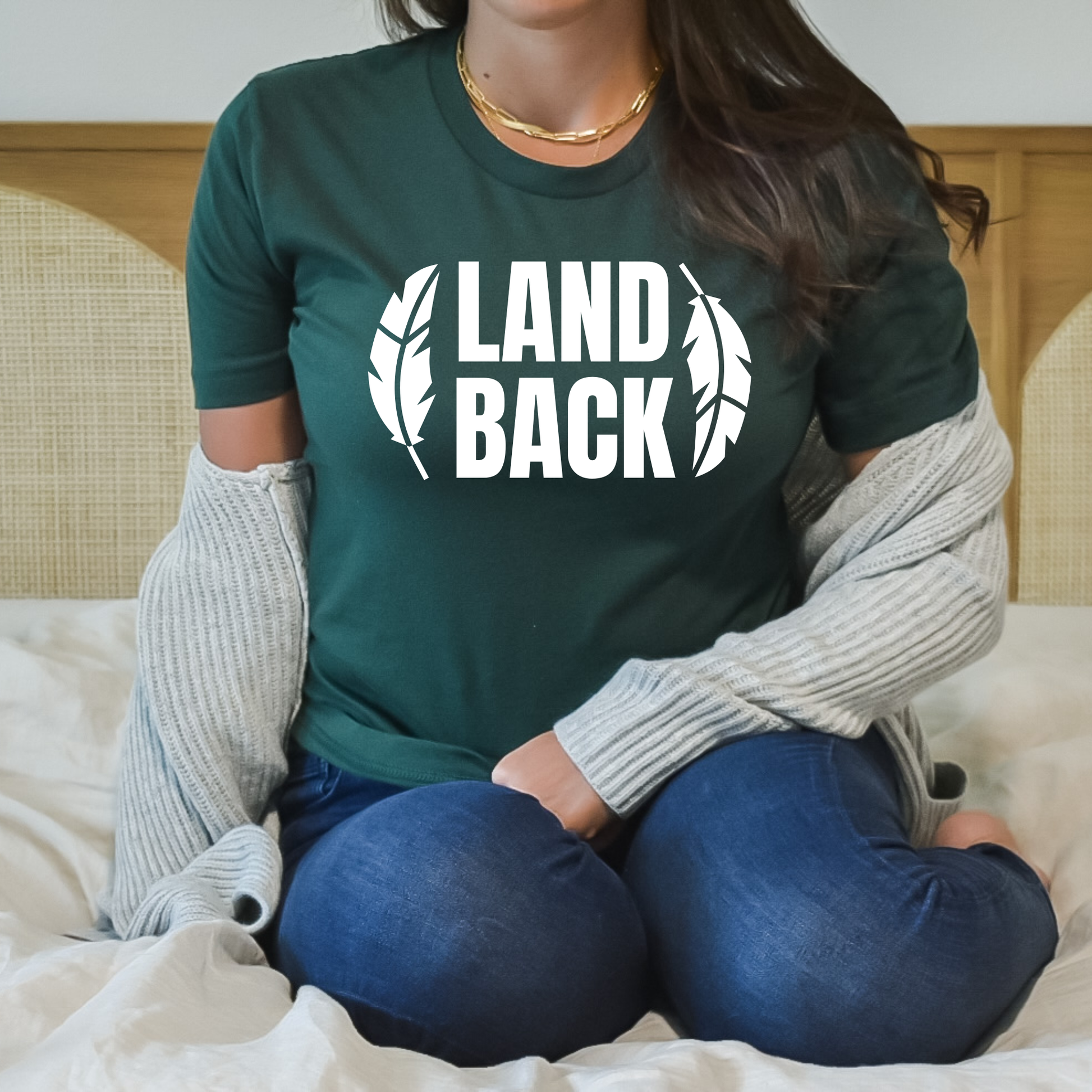 Land Back shirt featuring bold white lettering framed by two feathers, representing Indigenous sovereignty and Indigenous rights.land back shirt, indigenous shirt, indigenous rights shirt, indigenous sovereignty shirt, land back movement, decolonization shirt, indigenous advocacy apparel, indigenous activist shirt, truth and reconciliation shirt, orange shirt day apparel, national indigenous peoples day shirt, indigenous pride shirt, ally shirt, feather shirt, indigenous graphic tee, native rights shirt