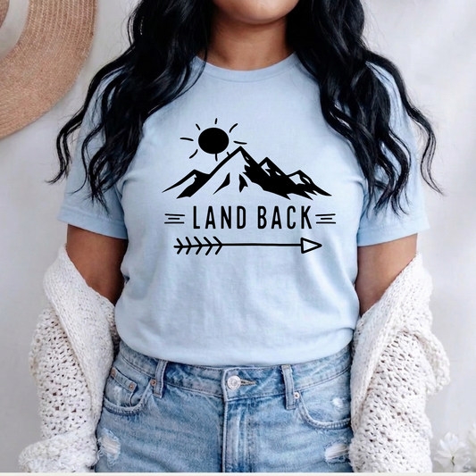 Land Back unisex t-shirt featuring original mountain and sun graphic design symbolizing Indigenous land return movement on soft comfortable cotton tee, perfect for activists and allies.